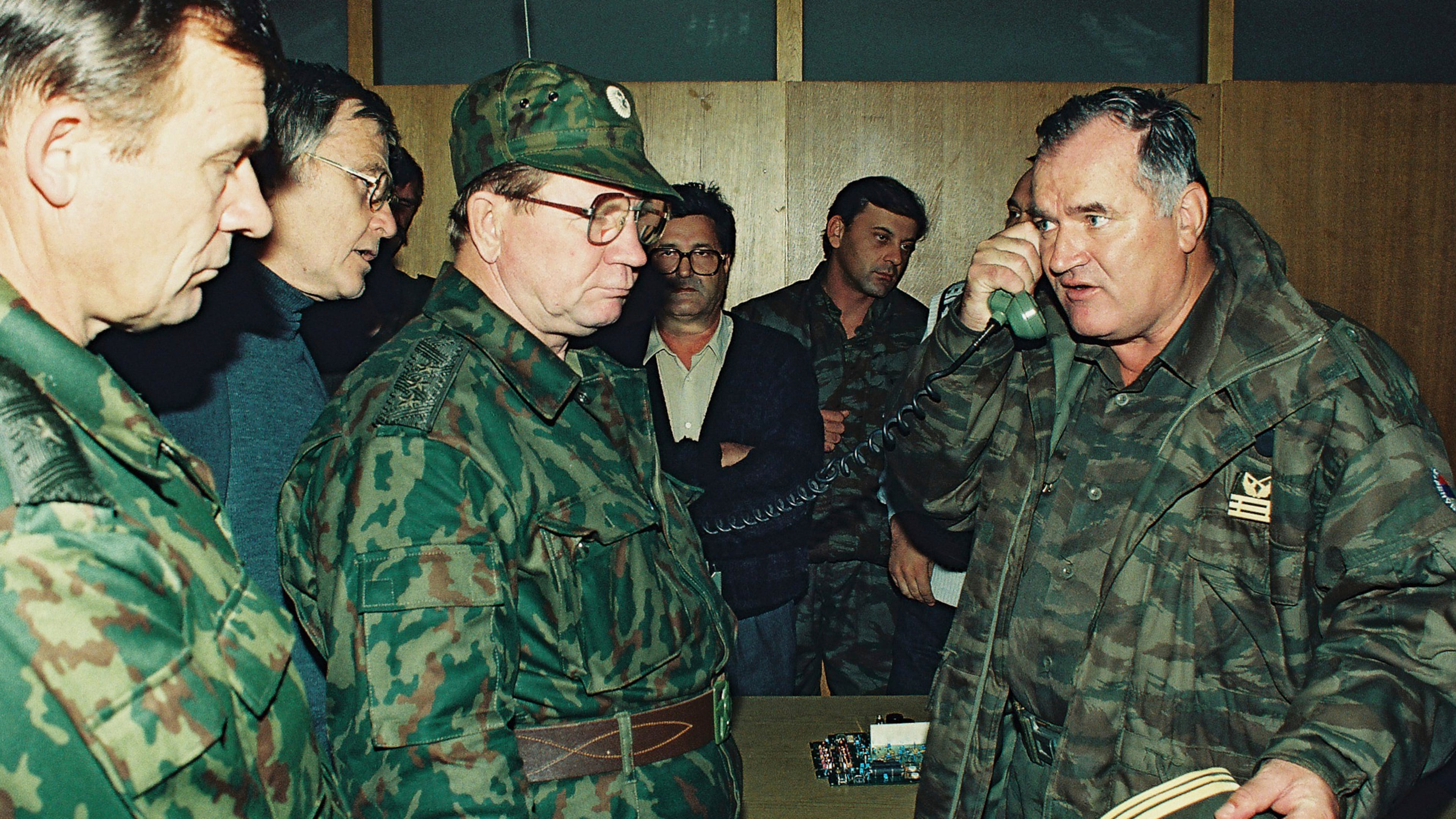 FILE - Bosnian Serb General Ratko Mladic, right, talks on the phone next to Russian Army General Vladimir Zurbenko, center, during the visit of a Russian Army delegation to the Bosnian town of Banja Luka in Oct. 1995. (AP Photo/Radivoje Pavicic, File)