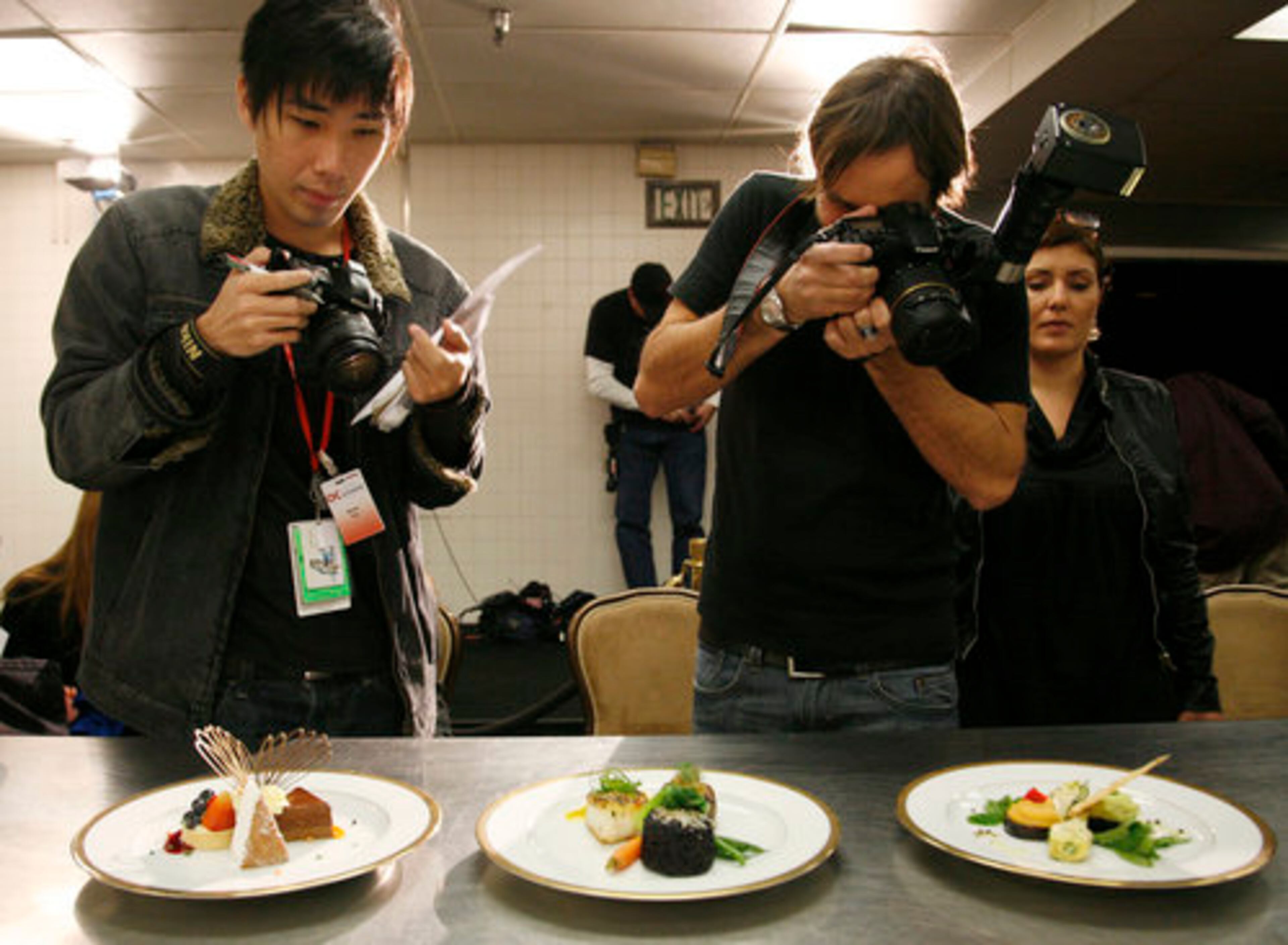 Photographers take pictures of the three-course meal.