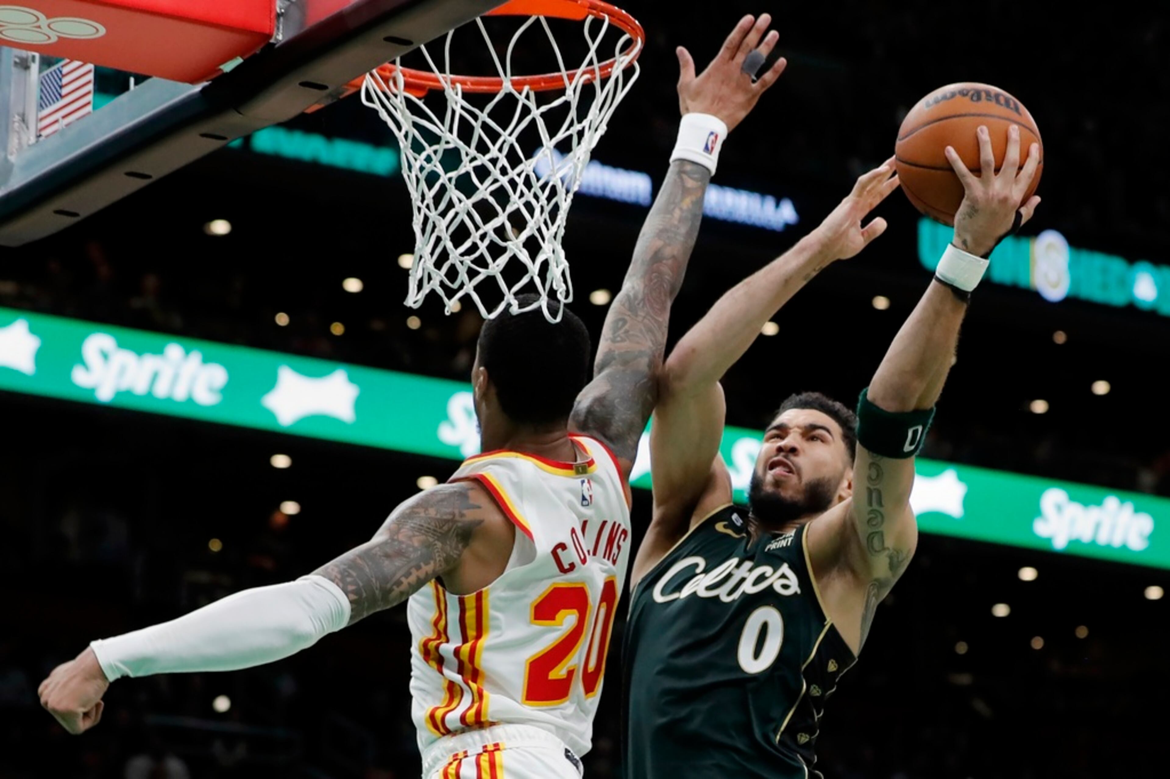 Boston Celtics' Jayson Tatum (0) shoots against Atlanta Hawks' John Collins (20) in the second half during Game 1 in the first round of the NBA basketball playoffs, Saturday, April 15, 2023, in Boston. (AP Photo/Michael Dwyer)