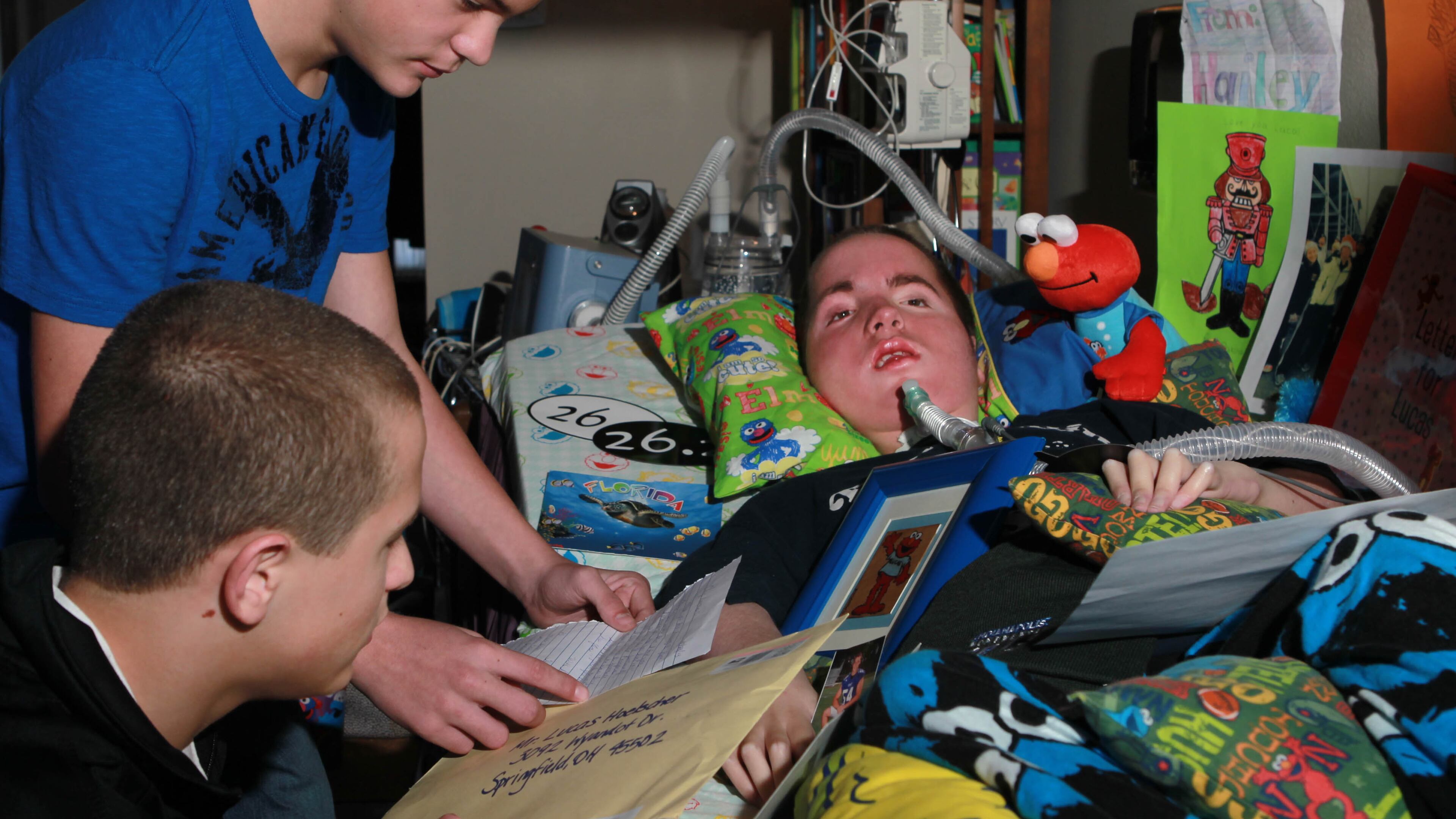 Lucas Hoelscher, a 14-year-old Springfield resident, suffers from spinal muscular atrophy type I, and the disease has left him with zero movement. When he was 10 months old, doctors told him he wouldn't live past age one. Lucas, part of triplet brothers Bailey (top) and Cameron (lower left), enjoys receiving mail and correspondence from near and far. JIM WITMER / STAFF