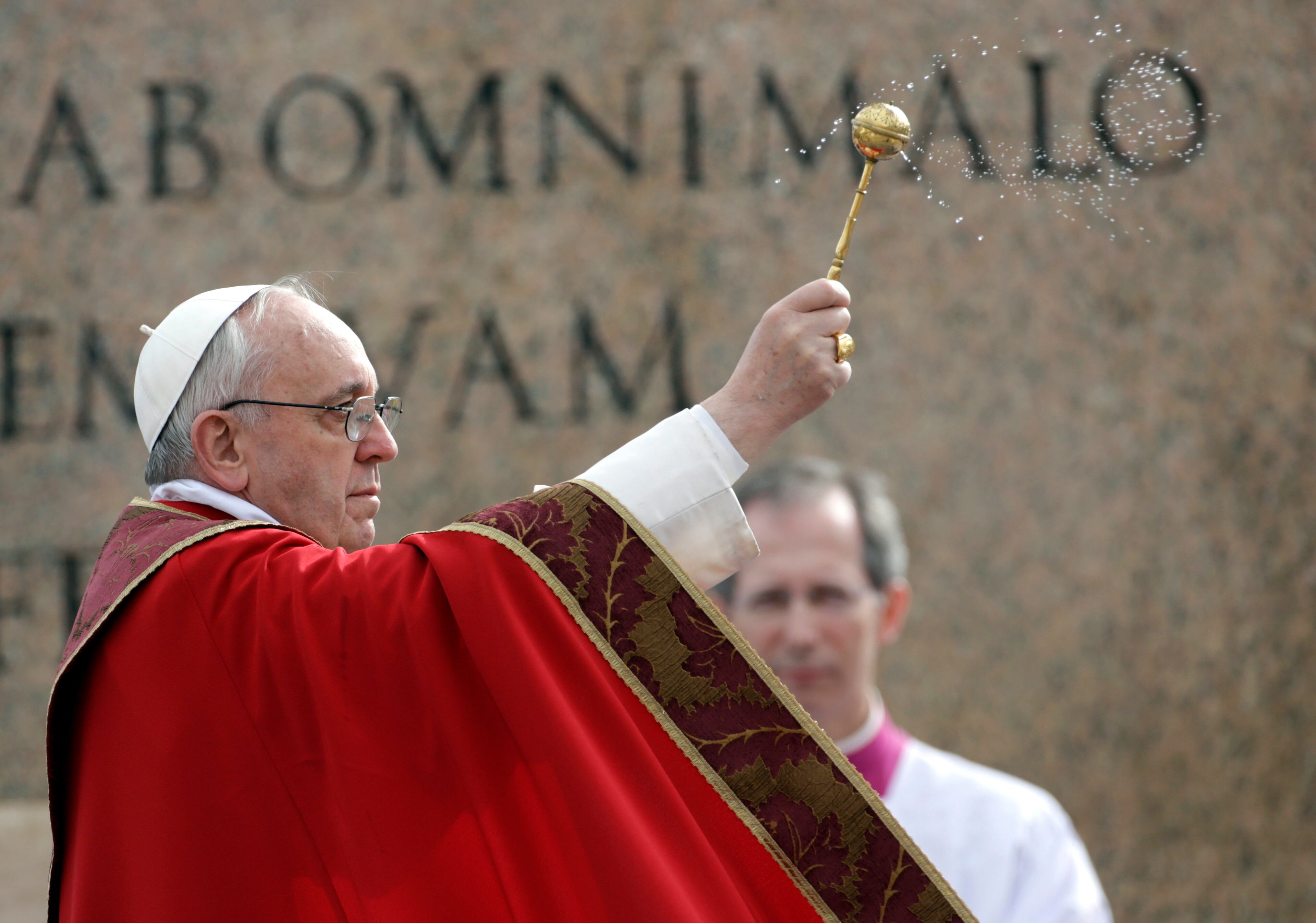 Pope Francis celebrates Palm Sunday Mass, in St. Peter's Square at the Vatican, Sunday, March 24, 2013. The new pontiff arrived in an uncovered vehicle to start solemn Holy Week ceremonies, which lead up to Easter, Christianity's most important day. Francis wore bright red robes over a white cassock and presided over the Mass from an altar sheltered by a canopy on the steps of St. Peter's Basilica. (AP Photo/Andrew Medichini)