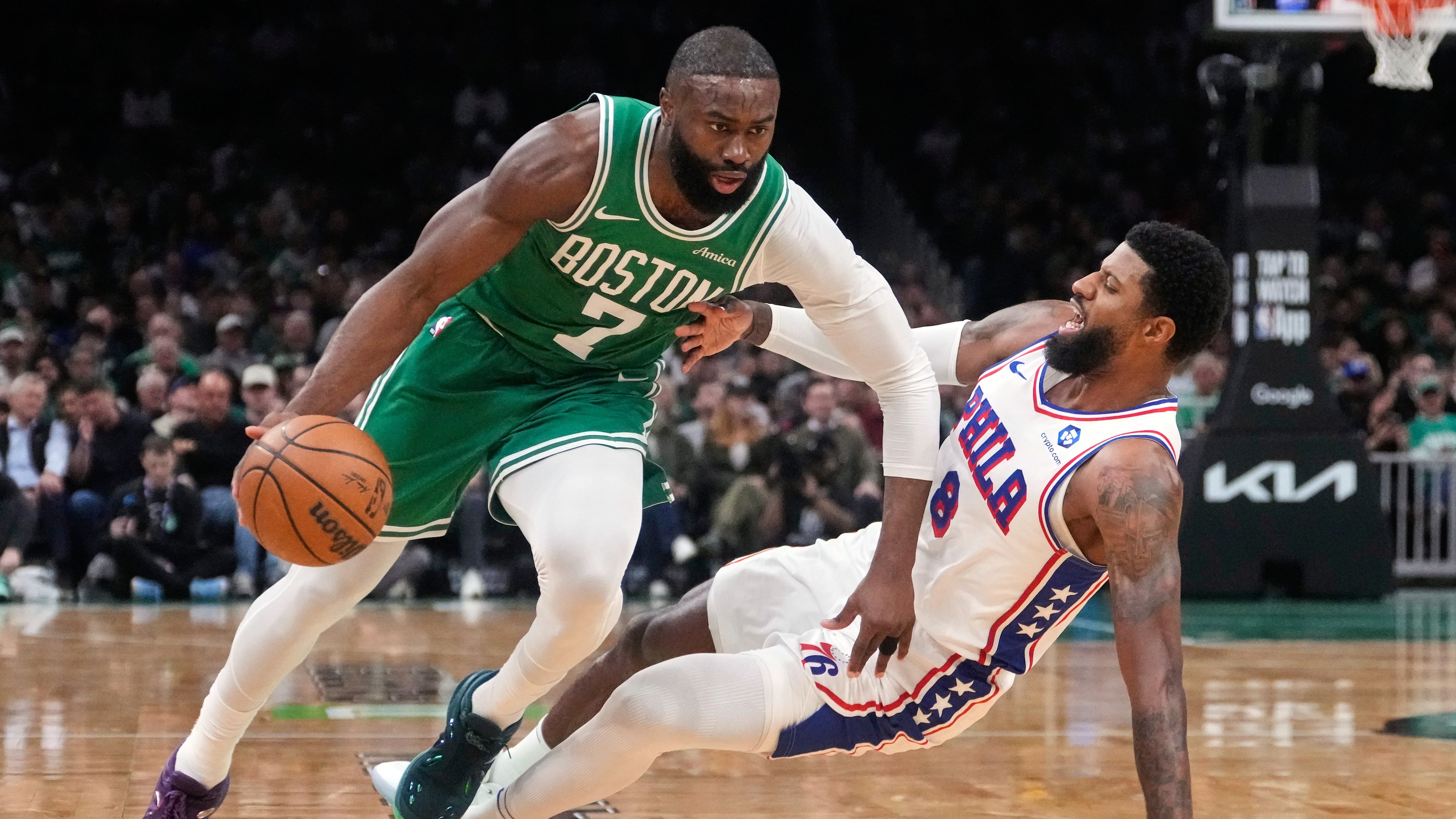 FILE - Boston Celtics guard Jaylen Brown (7) drives to the basket against Philadelphia 76ers forward Paul George (8) during the first half of Game 2 of a first-round NBA playoffs basketball series, April 21, 2026, in Boston. (AP Photo/Charles Krupa, File)