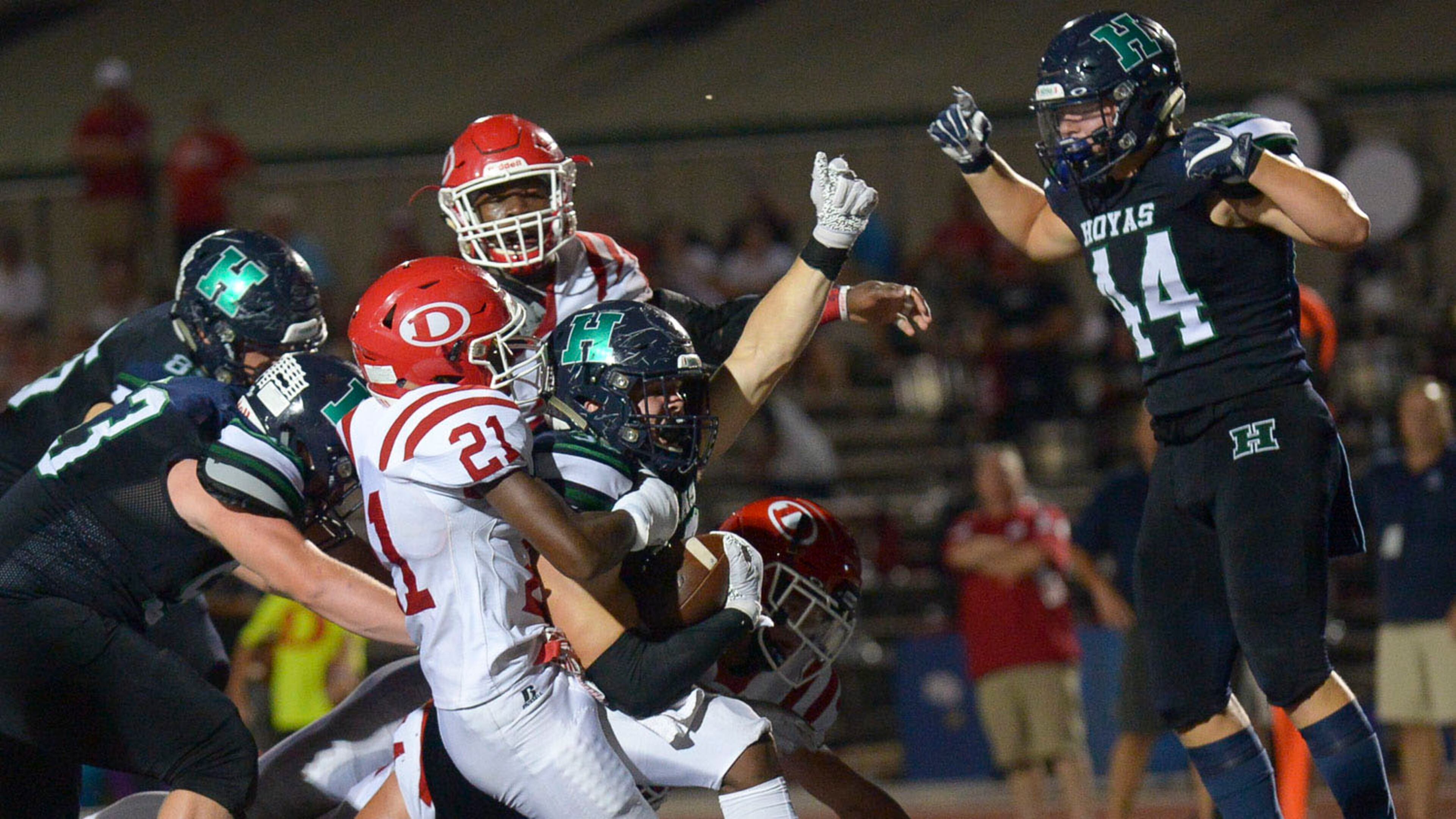 Let's get pumped up: Harrison's Marcus Bleazard (32) breaks through a tackle by Dalton's Malachi Gregory (21) to score a touchdown late in the second half of Friday's game at Harrison. (Daniel Varnado/Special)