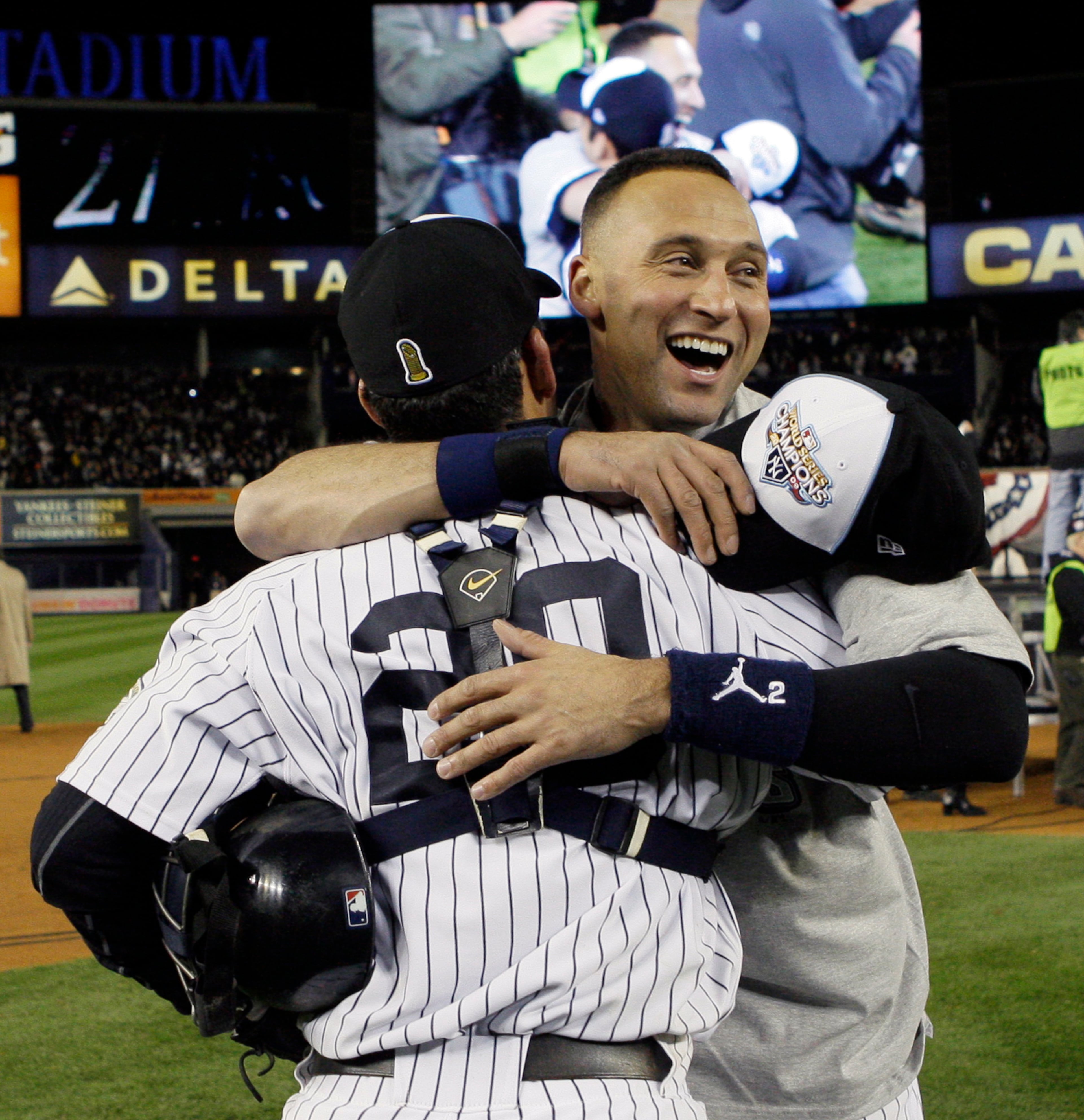 FILE - In this Nov. 4, 2009, file photo, New York Yankees' Jorge Posada (20) and Derek Jeter celebrate after the ninth inning of Game 6 of the Major League Baseball World Series against the Philadelphia Phillies in New York. Jeter is set to retire after this weekend. A five-time World Series champion and sixth on the career hits list, he spent two decades as the shortstop for the New York Yankees. (AP Photo/Elise Amendola, File)
