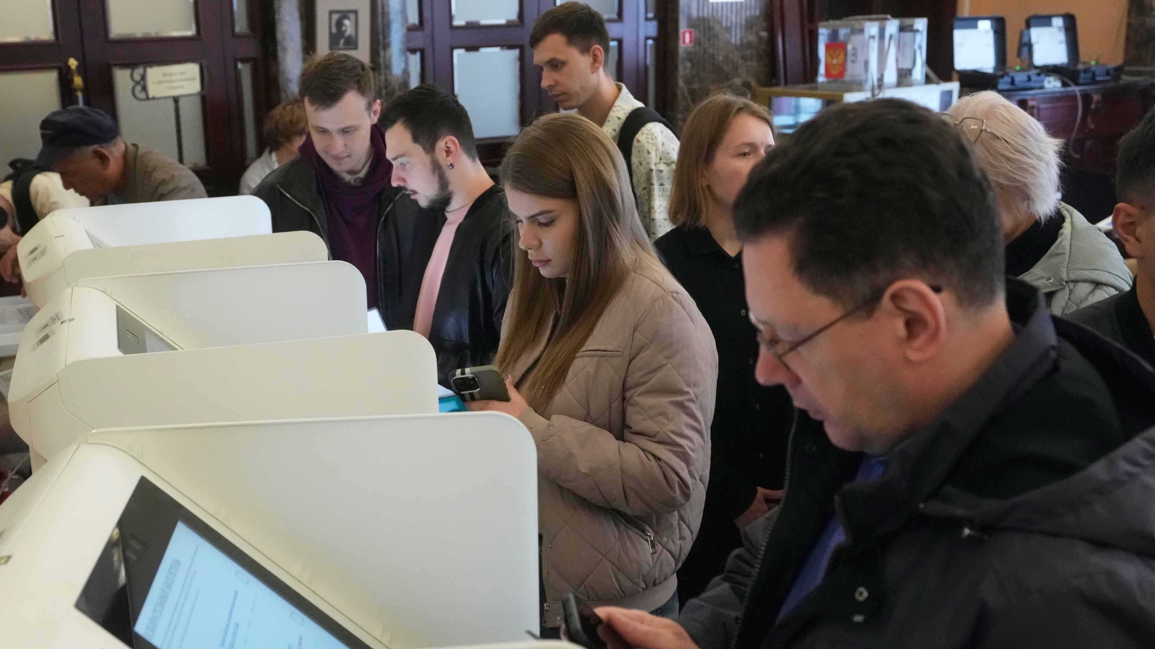 Voters use an electronic voting system in the parliamentary election in Moscow, Friday, Sept. 18, 2026. (AP Photo/Pavel Bednyakov)
