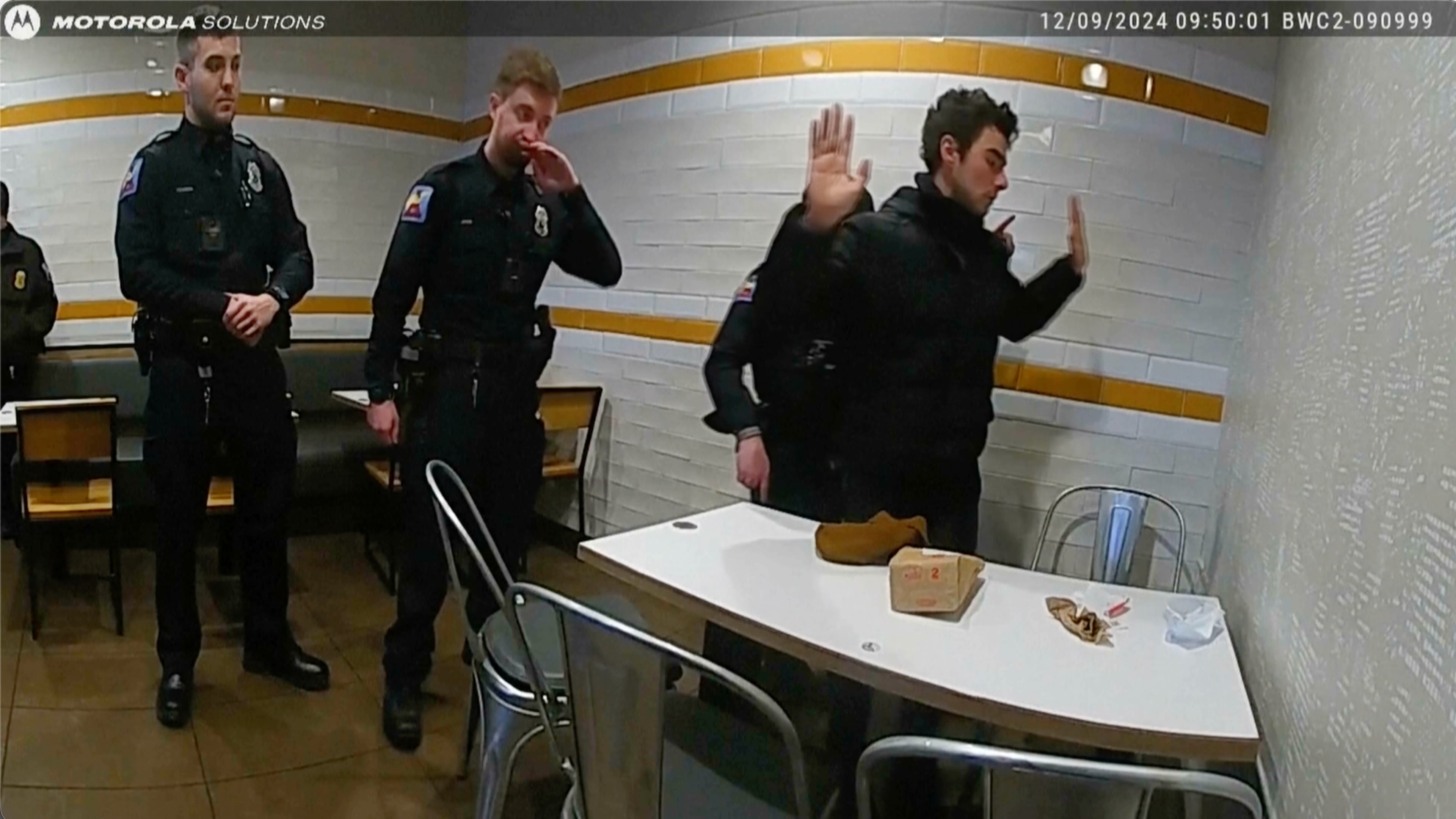 This image, provided by the Altoona Police Department, shows body camera footage of police officers arresting Luigi Mangione in Altoona, Pa., on Dec. 9, 2024.(Altoona Police Department via AP)
