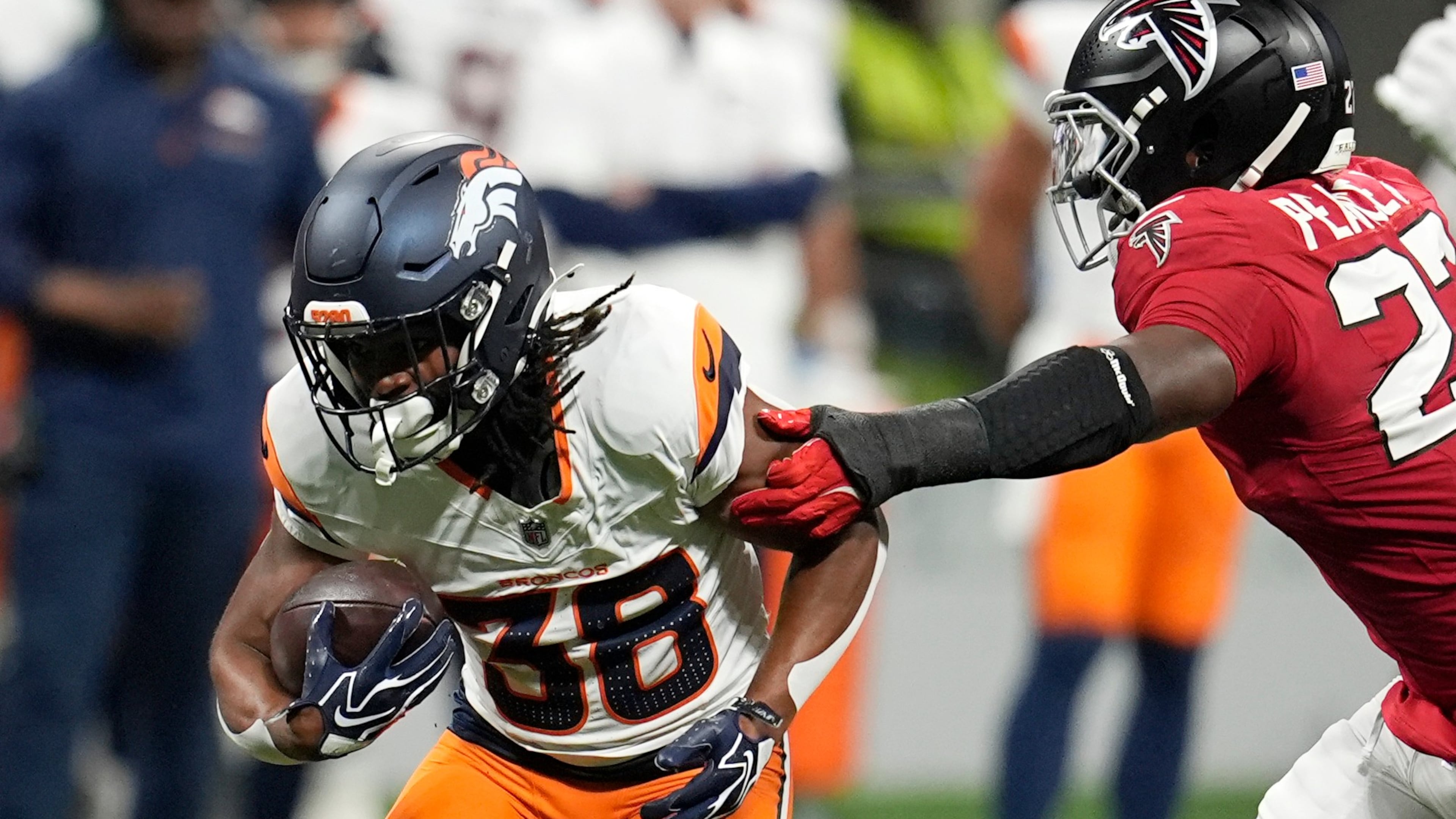 Denver Broncos running back Jaleel McLaughlin (left) runs against Atlanta Falcons linebacker James Pearce Jr. (right) during the first half of a preseason NFL football game, Friday, Aug. 14, 2026, in Atlanta. (Mike Stewart/AP)