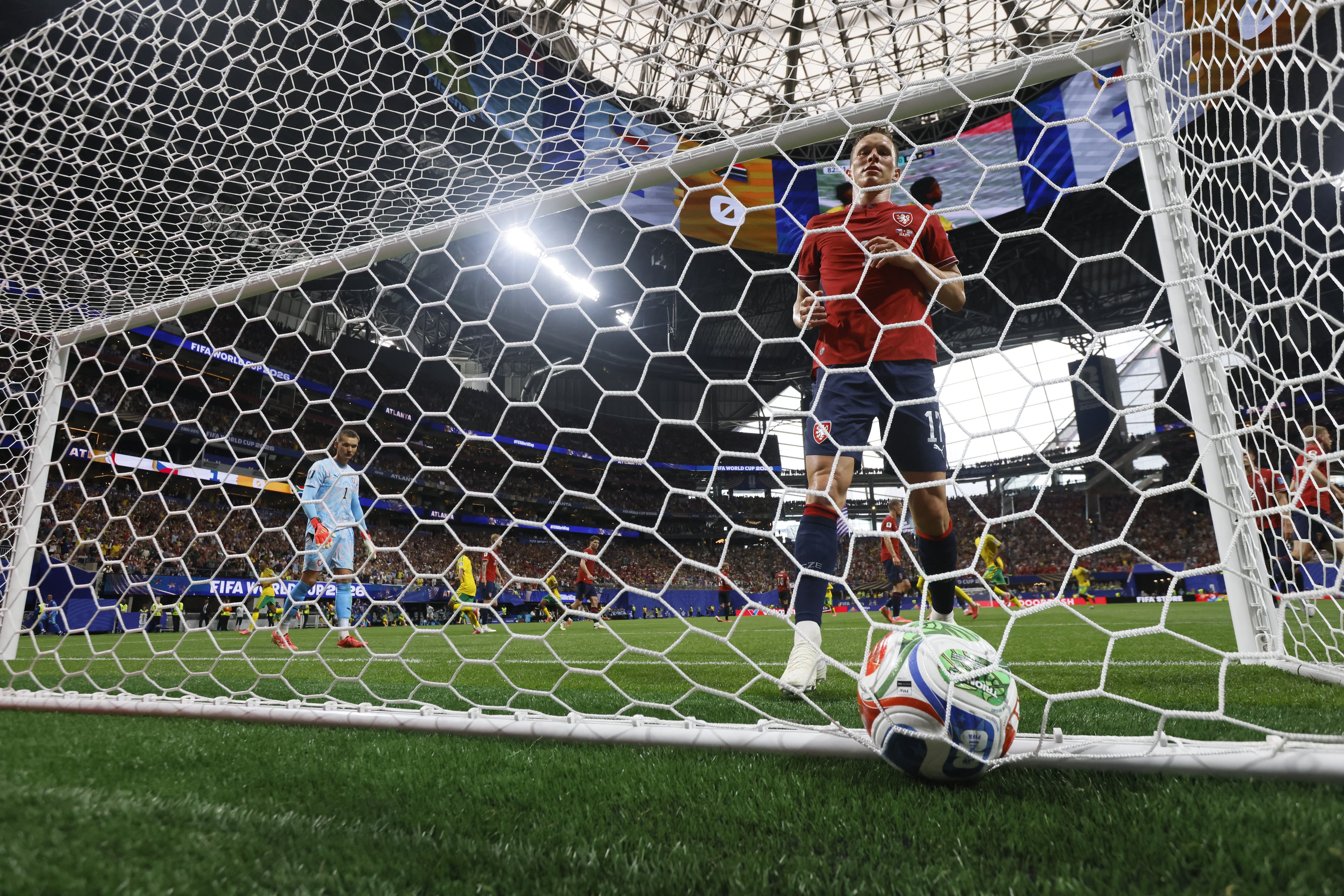 Czechia's Lukas Provod right and Czechia goalkeeper Matej Kovar look back into the net at the ball just kicked by South Africa's Teboho Mokoena for a penlty kick goal during second half of Czechia vs. South Africa Group A FIFA World Cup match at Atlanta Stadium (Mercedes-Benz Stadium) on Thursday, June 18, 2026. (Miguel Martinez/AJC)