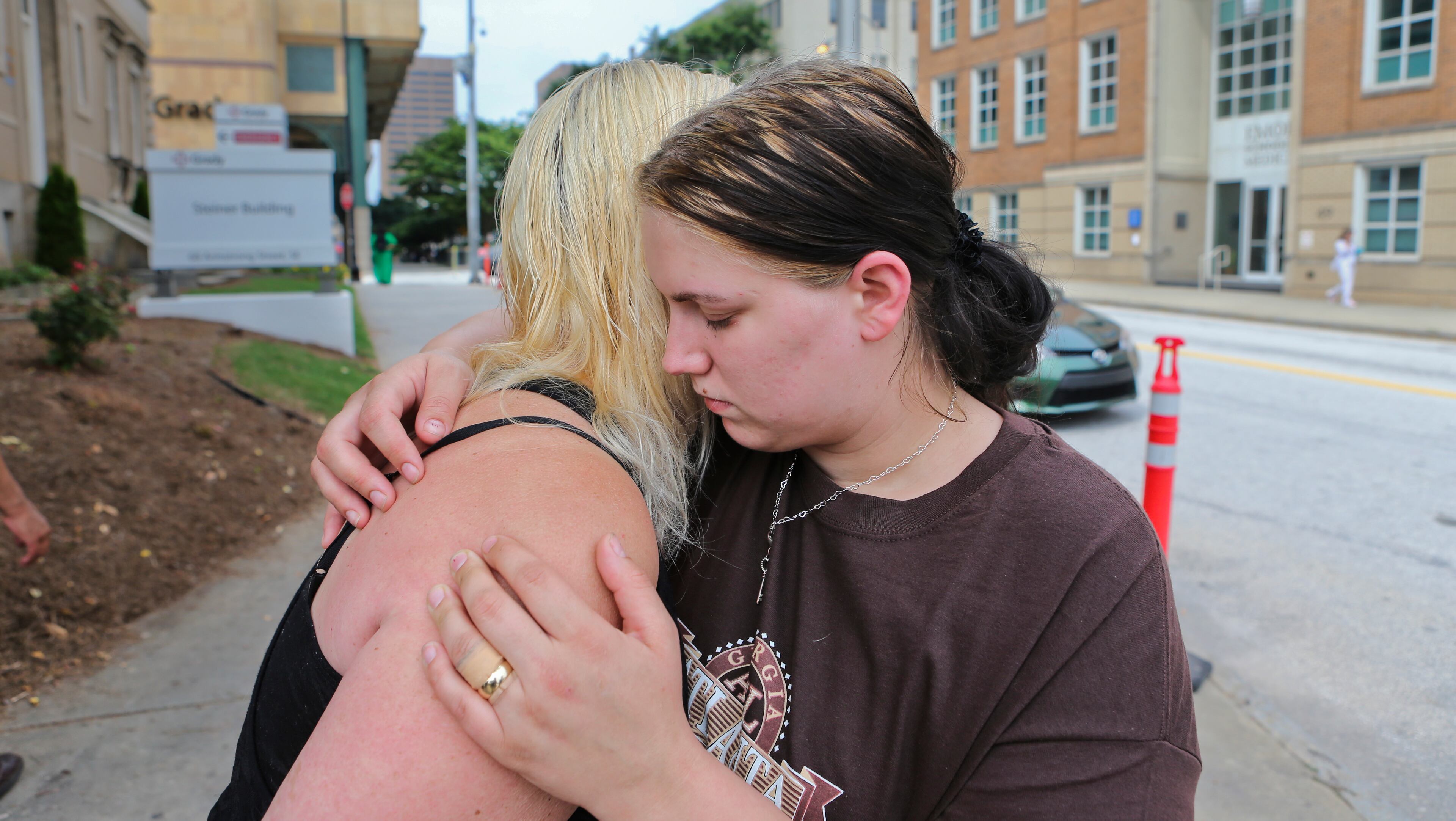 Alecia Phonesavanh (left) hugs her mother, Marlene Haygood, outside Grady Memorial Hospital in Atlanta on Friday.