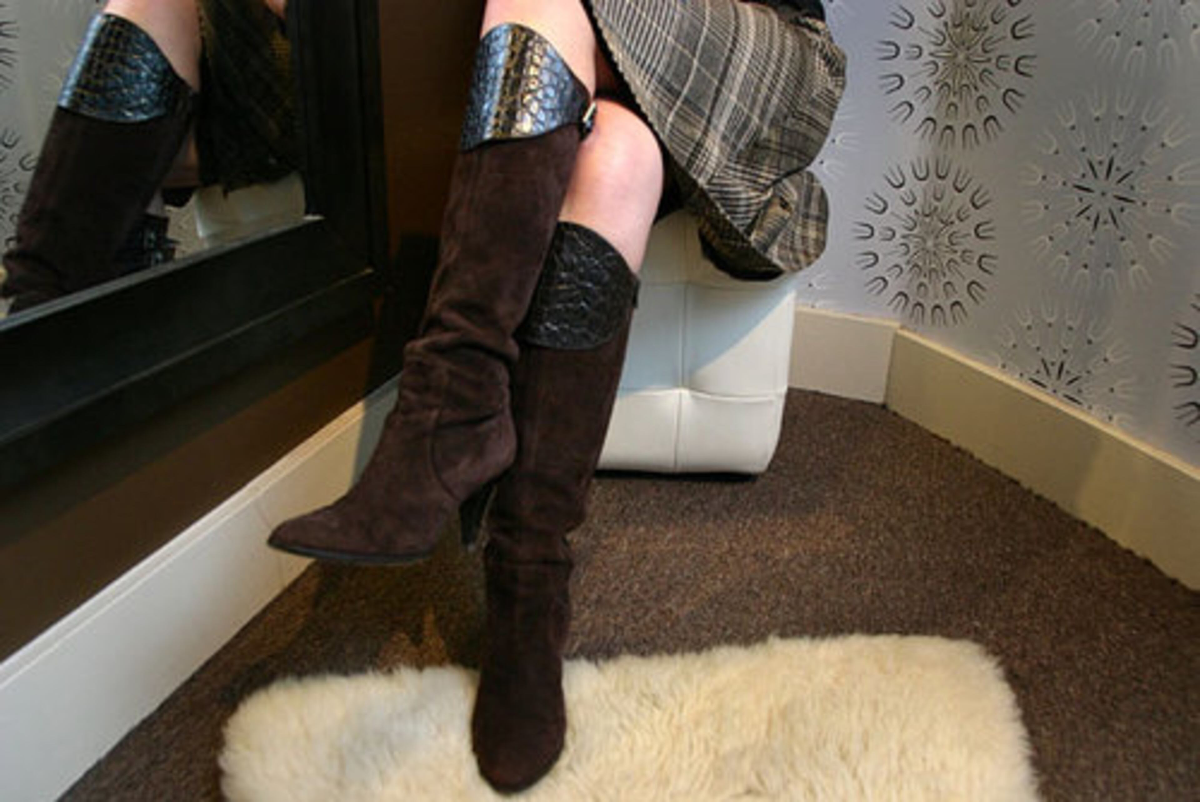 Blanco shows off a skirt from Zara and her Italian boots by Max de Carlo.