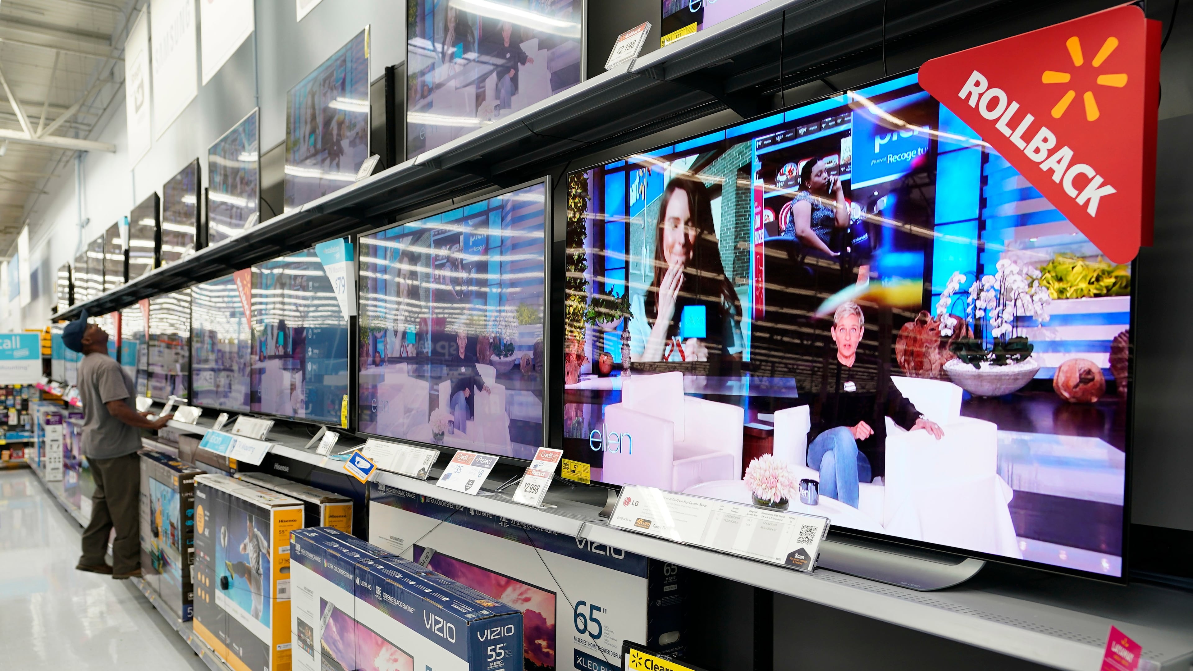 FILE - In this Nov. 9, 2018, file photo shoppers look at televisions at a Walmart Supercenter in Houston. (AP Photo/David J. Phillip, File)