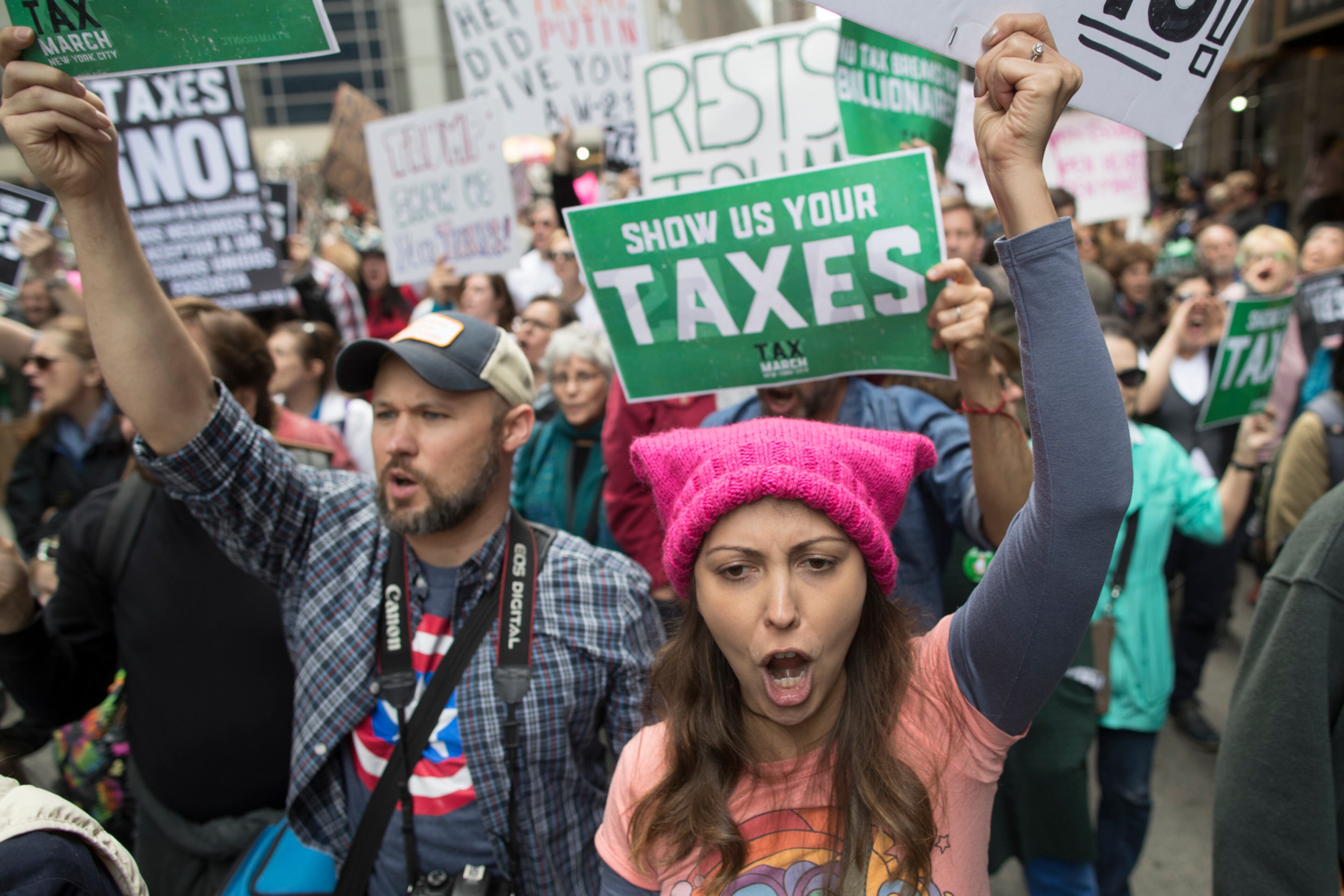 Demonstrators participate in a march and rally to demand President Donald Trump release his tax returns, Saturday, April 15, 2017, in New York. Protesters took to the streets in dozens of cities nationwide Saturday to call on President Donald Trump to release his tax returns, saying Americans deserve to know about his business ties and potential conflicts of interest. (AP Photo/Mary Altaffer)