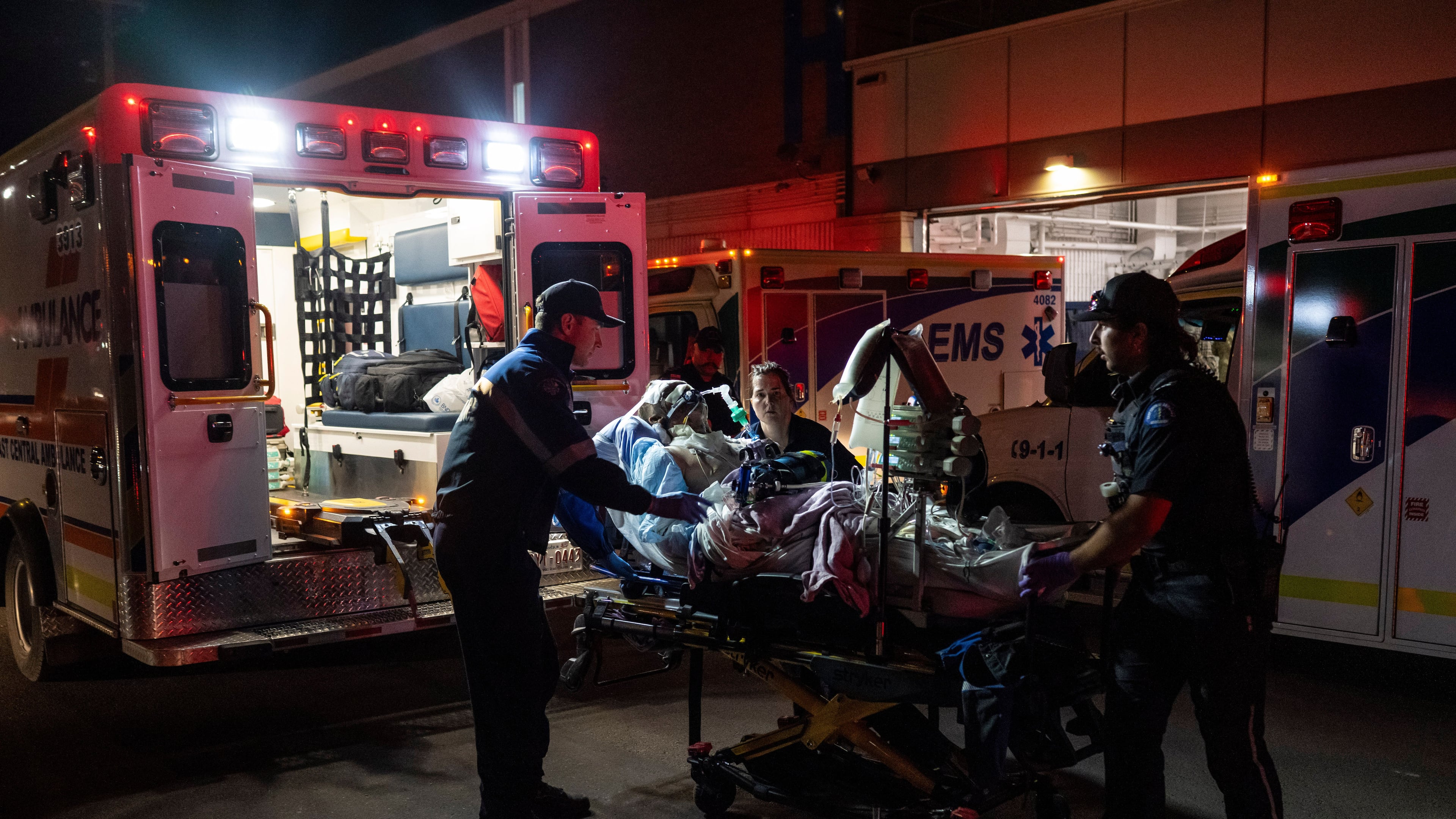 Paramedics load an injured person into an ambulance at the Wainwright Health center after a fire at Canadian Forces Base Wainwright, outside of Wainwright, Alberta Saturday, Oct. 17, 2026. (John Ulan/The Canadian Press via AP)