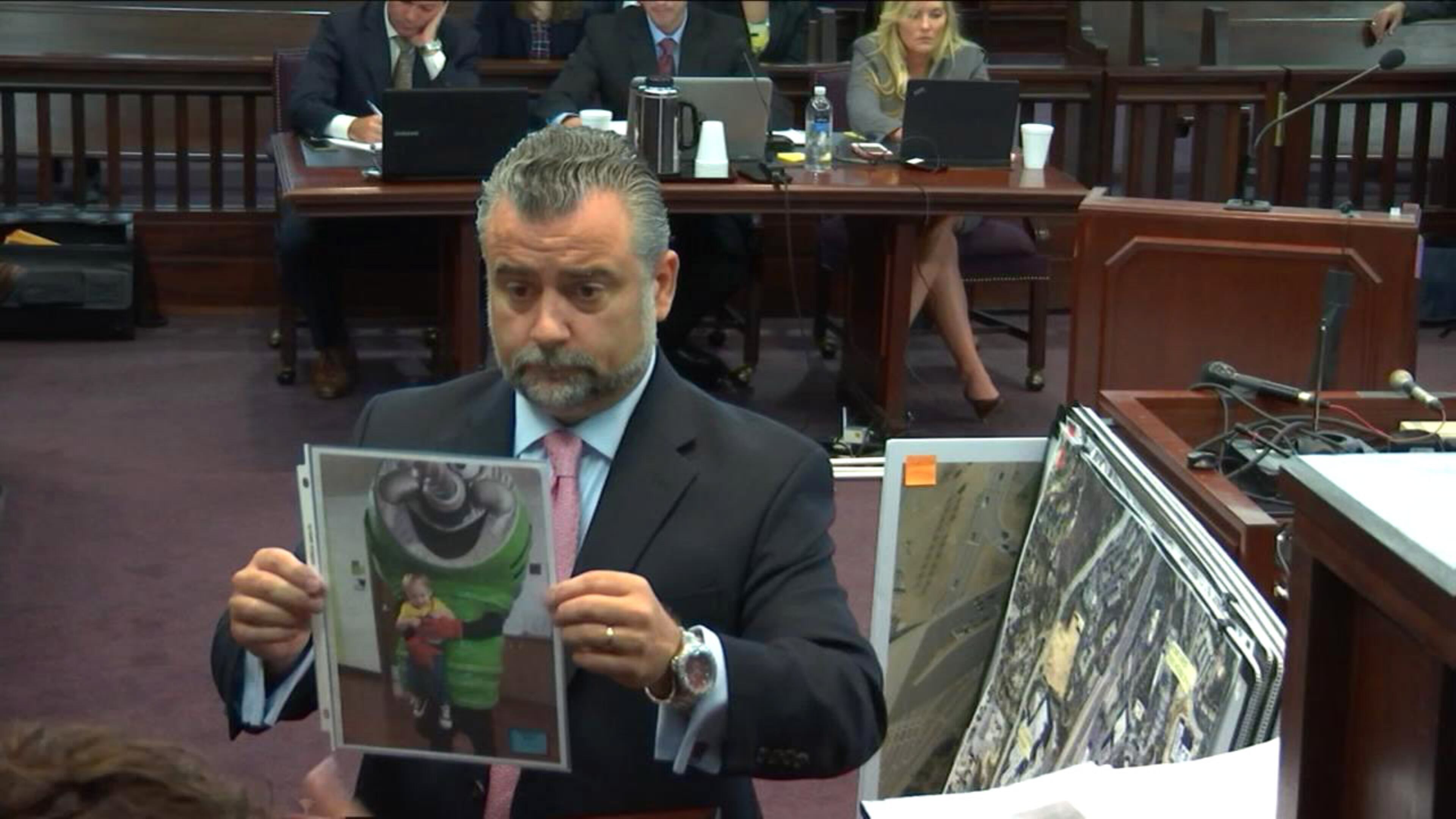 Defense attorney Maddox Kilgore shows an image of Ross Harris dressed in costume during a visit to Cooper's day care, during Harris' murder trial at the Glynn County Courthouse in Brunswick, Ga., on Wednesday, Oct. 13, 2016. Kilgore was portraying Harris as an engaged father. (screen capture via WSB-TV)