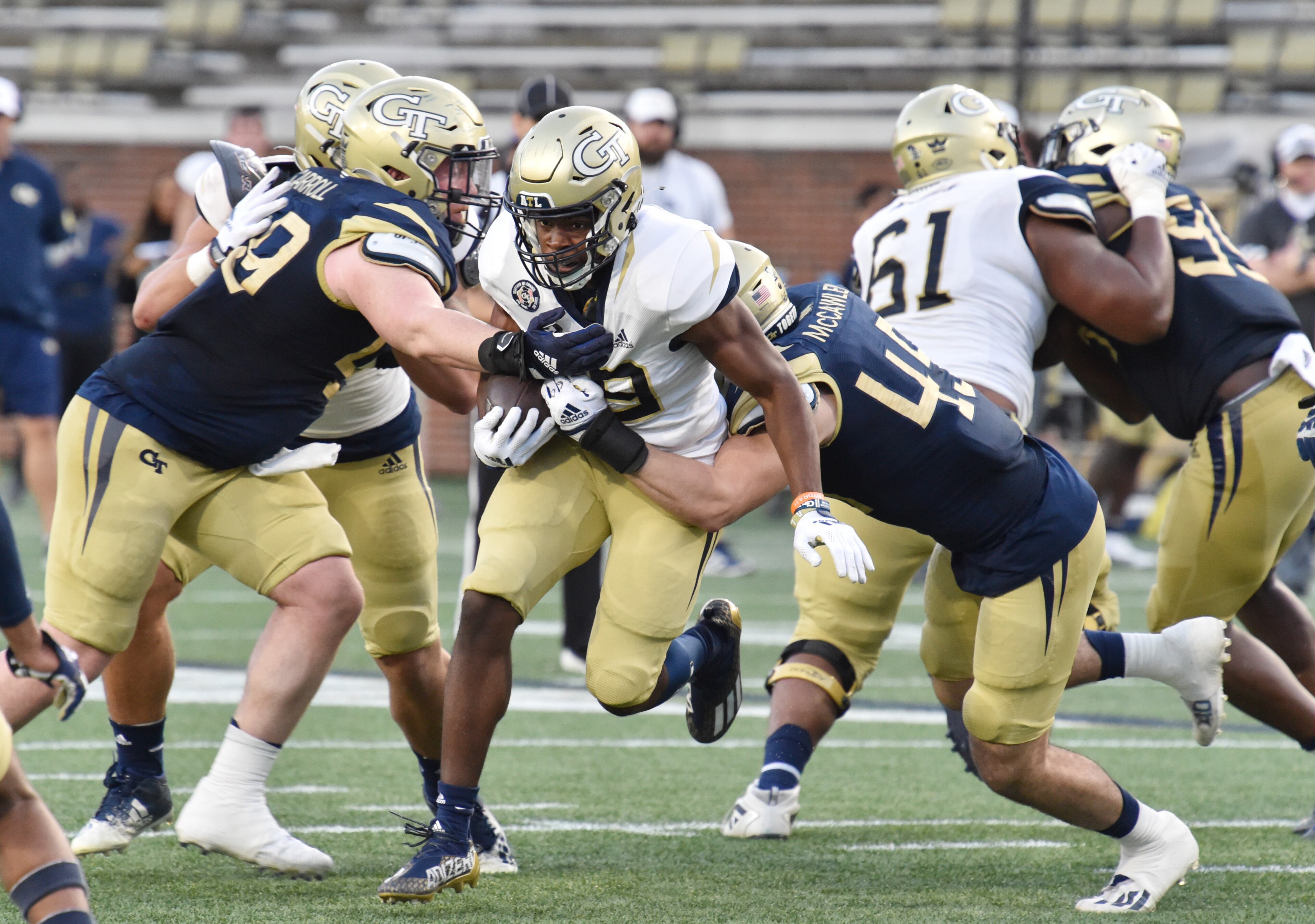 Georgia Tech's running back Englan Williams (39) gets tackled by defensive lineman Grey Carroll (49) and linebacker Taylor McCawley (45) during the 2022 Spring Game at Georgia Tech's Bobby Dodd Stadium in Atlanta on Thursday, March 17, 2022. (Hyosub Shin / Hyosub.Shin@ajc.com)