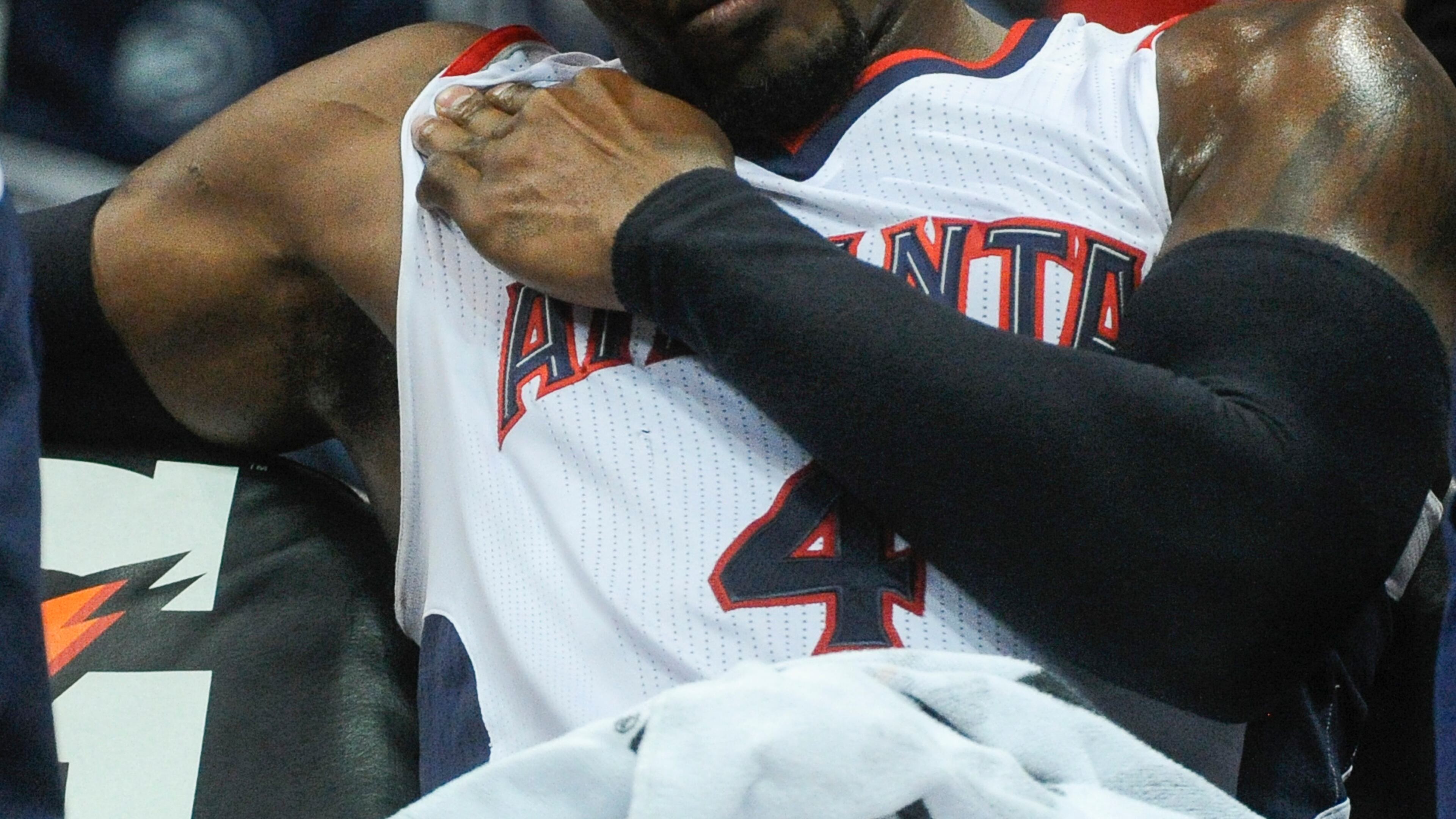 Atlanta Hawks forward Paul Millsap (4) holds his shoulder after being injured on the court during the first half of an NBA basketball game against the Brooklyn Nets, Saturday, April 4, 2015, in Atlanta. (AP Photo/John Amis) Paul Millsap sits on the bench shortly after suffering shoulder injury. (AP photo)