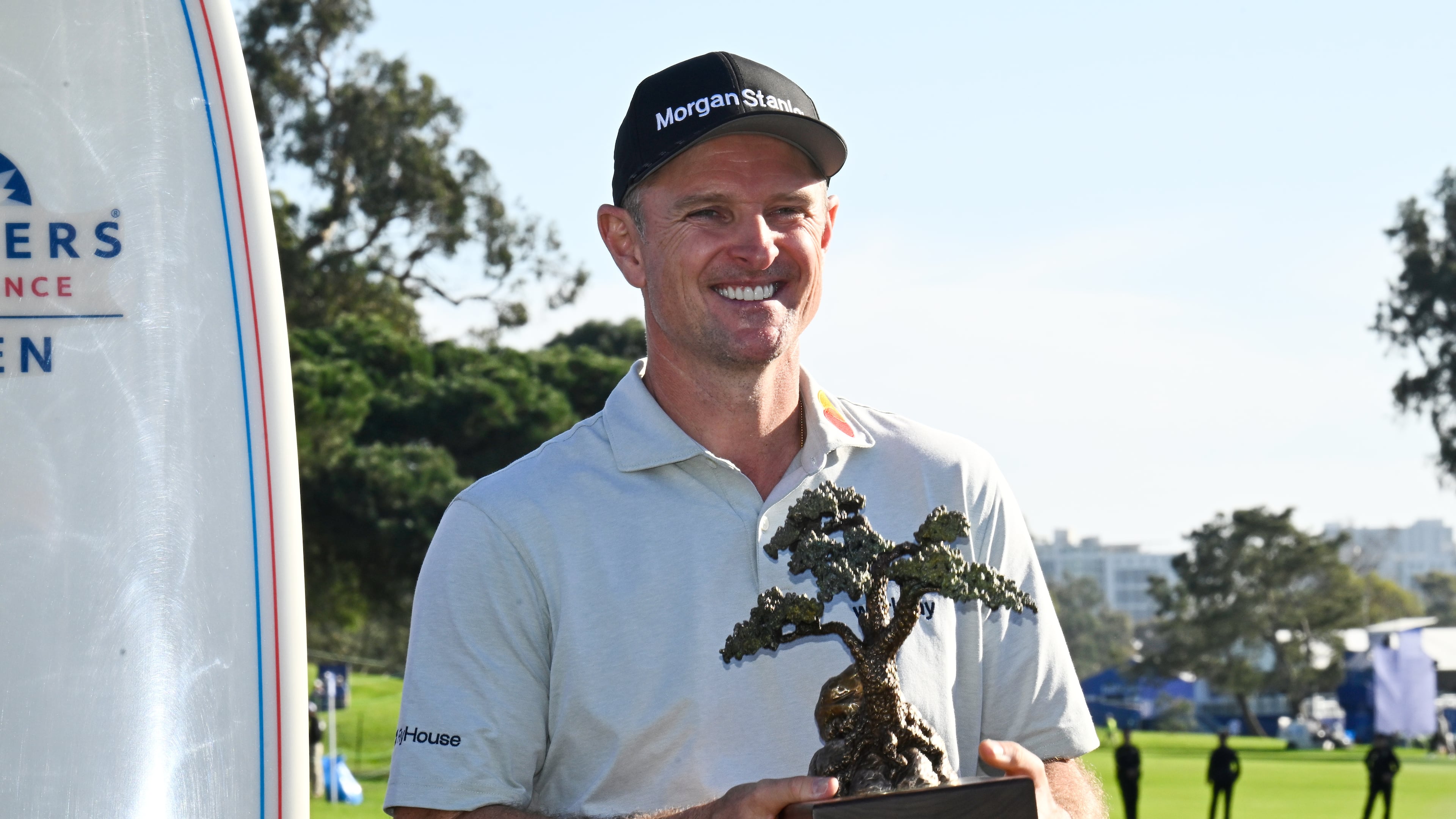 Justin Rose, of England, holds the winner's trophy at the Farmers Insurance Open golf tournament Sunday, Feb. 1, 2026, at Torrey Pines in San Diego. (AP Photo/Denis Poroy)