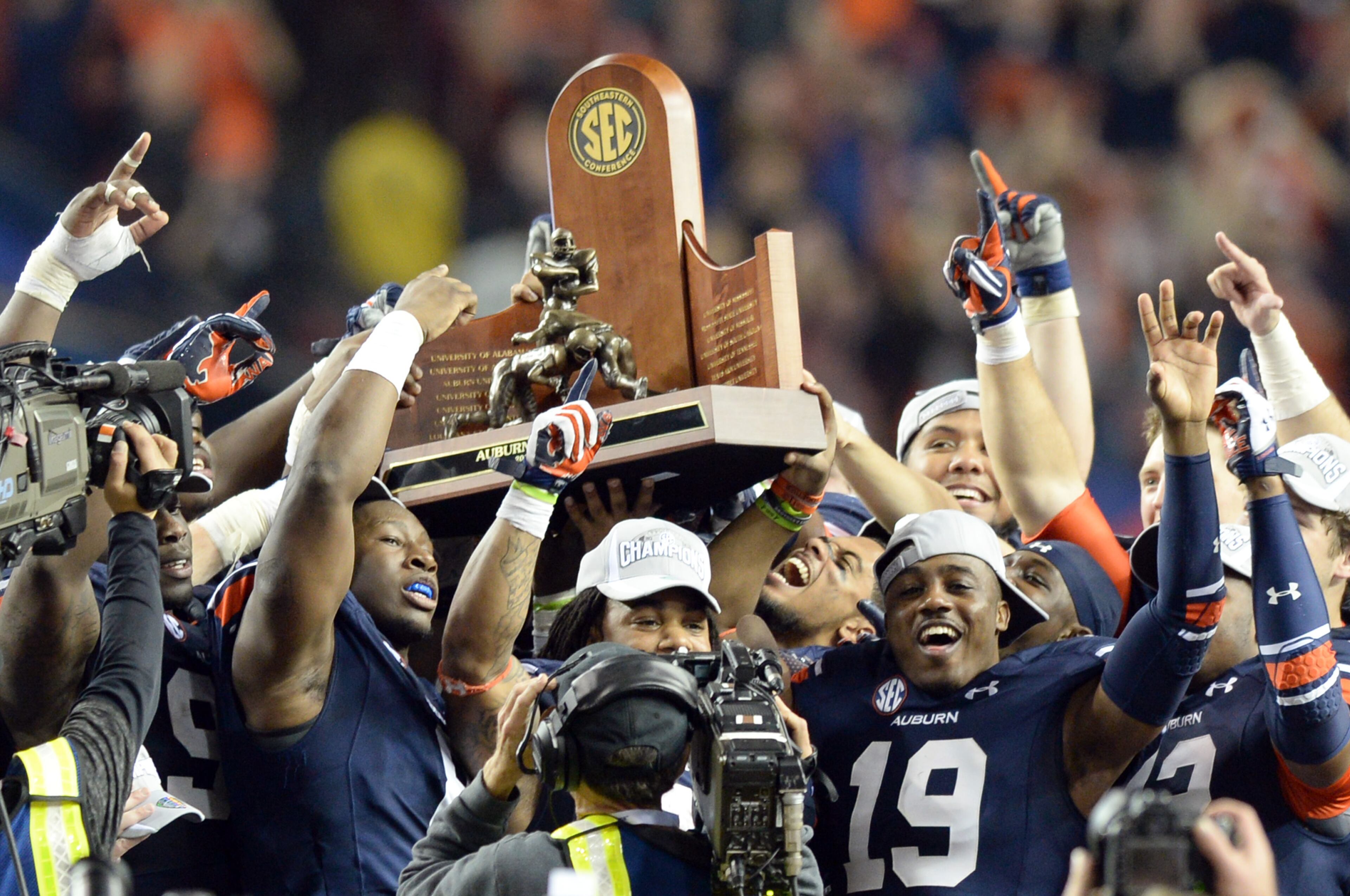 Auburn Tigers hold the championship trophy after they won 59-42 over the Missouri Tigers during the SEC Championship game at Georgia Dome on Saturday, December 7, 2013. HYOSUB SHIN / HSHIN@AJC.COM