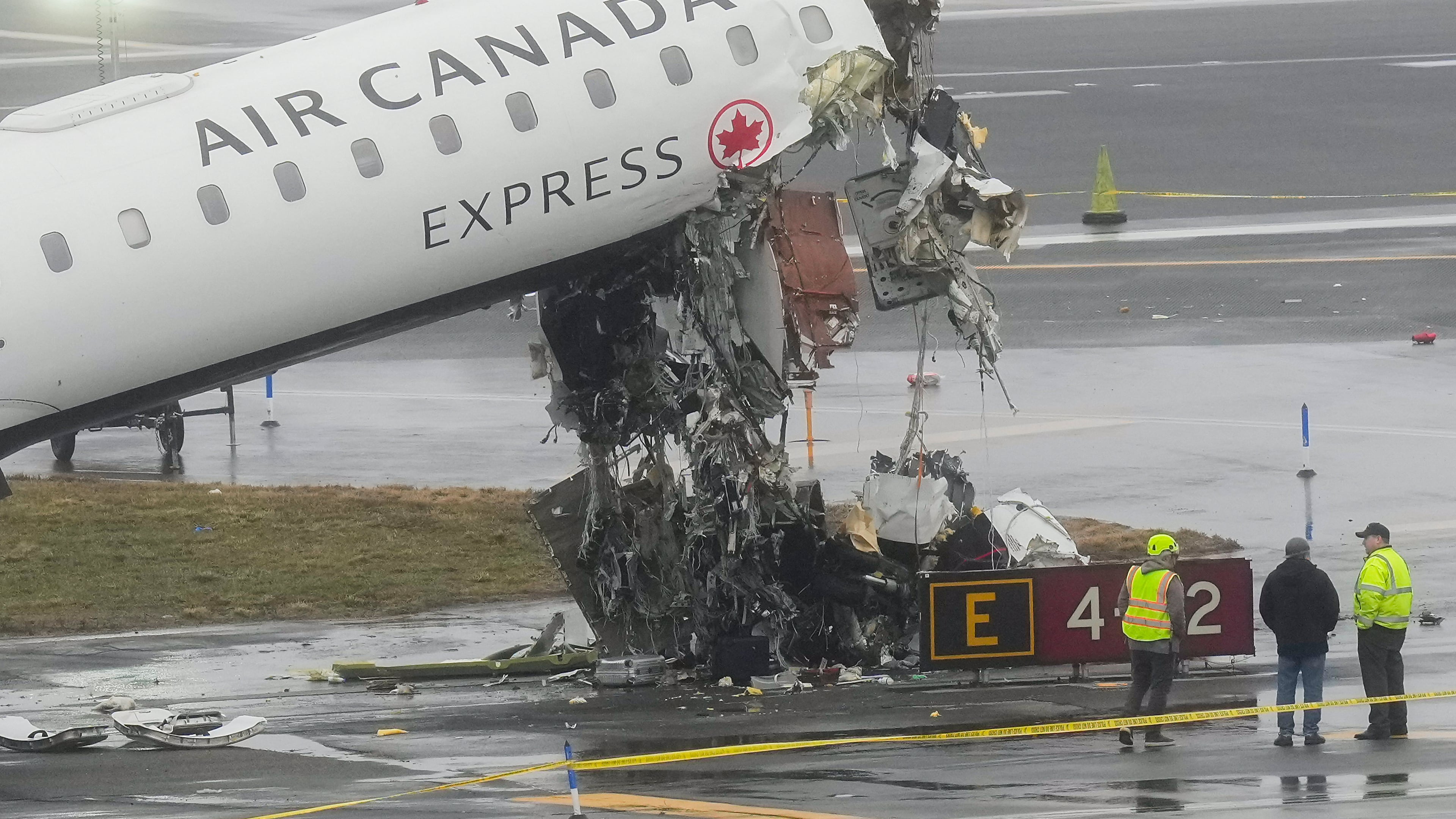 FILE - Officials investigate the site, Monday, March 23, 2026, where an Air Canada jet came to rest after colliding with a Port Authority firetruck at LaGuardia Airport, shortly after landing Sunday night in New York. (AP Photo/Seth Wenig, file)