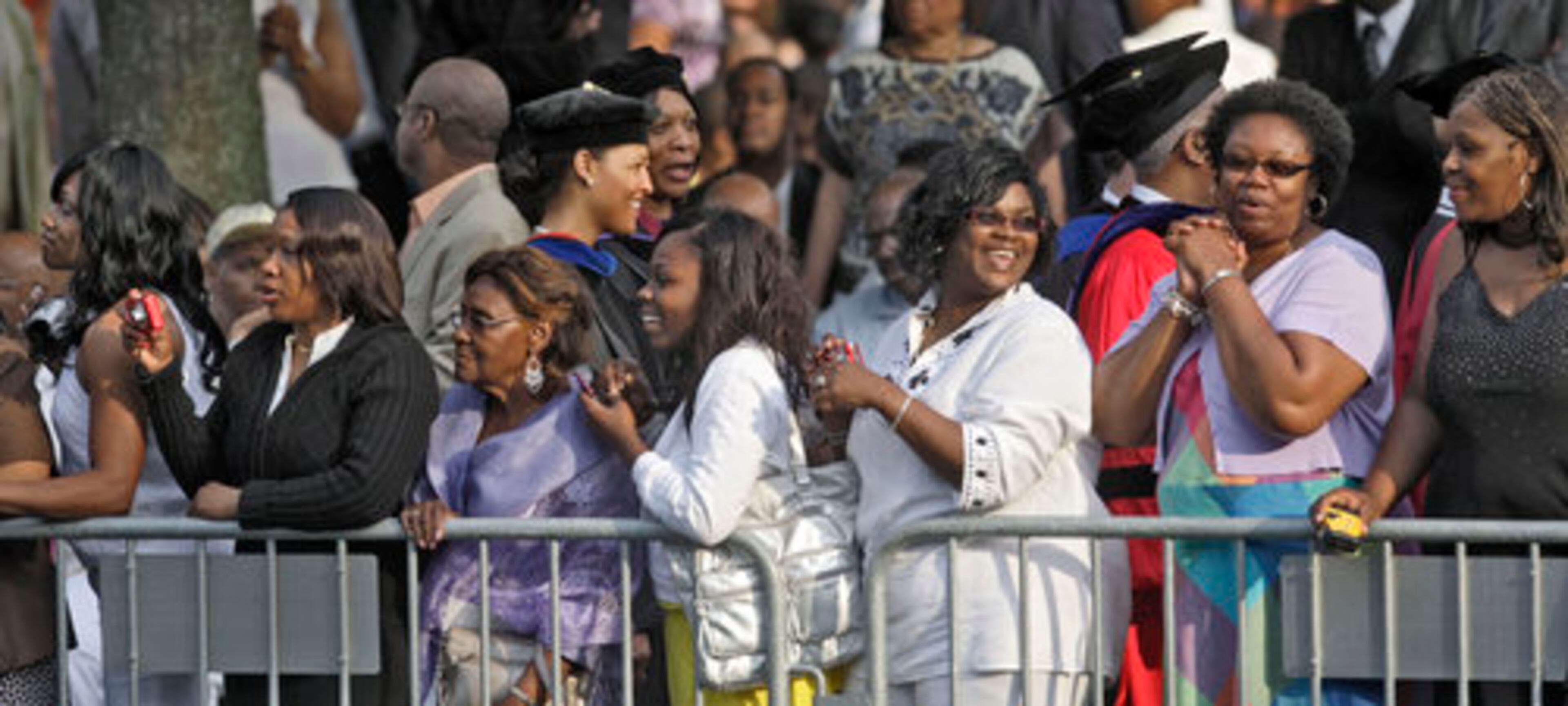 Family and friends strain to get a glimpse of their graduate during the processional.