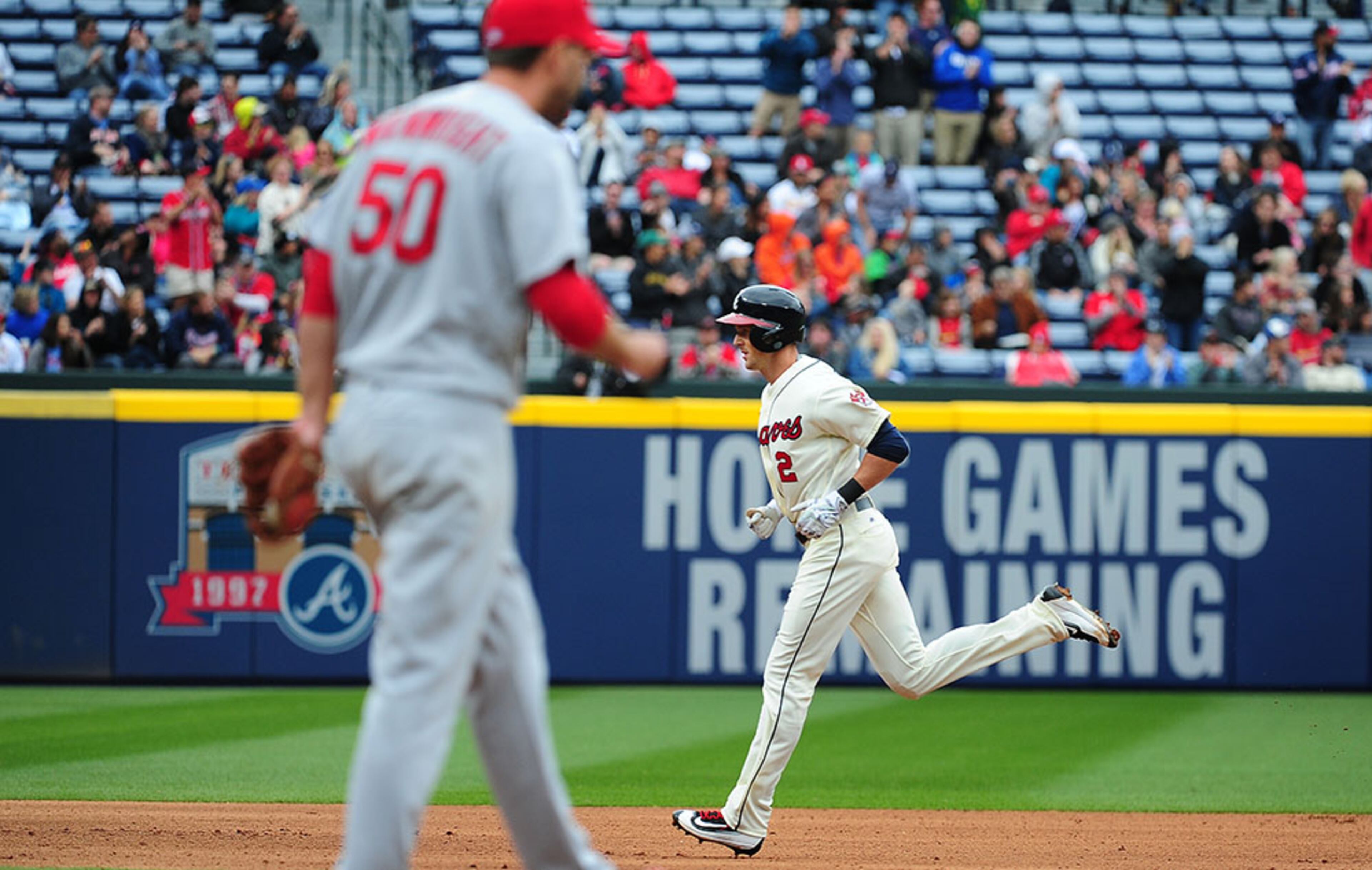 Drew Stubbs, (2) of the Atlanta Braves, rounds the bases after hitting a fourth inning three-run home run against St Louis Cardinals starter Adam Wainwright (foreground) at Turner Field on April 10, 2016 in Atlanta.