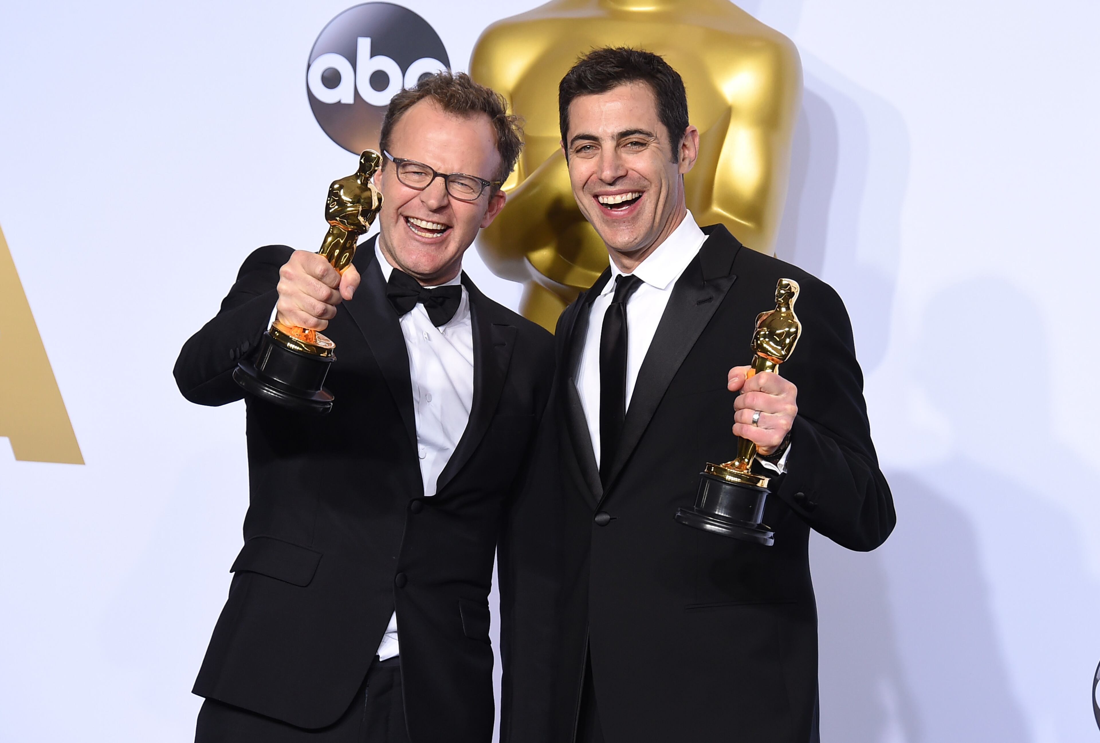 ** EMBARGOED AT THE REQUEST OF THE ACADEMY OF MOTION PICTURE ARTS & SCIENCES FOR USE UPON CONCLUSION OF THE ACADEMY AWARDS TELECAST ** Tom McCarthy, left, and Josh Singer pose with the award for best original screenplay for Spotlight in the press room at the Oscars on Sunday, Feb. 28, 2016, at the Dolby Theatre in Los Angeles. (Photo by Jordan Strauss/Invision/AP)