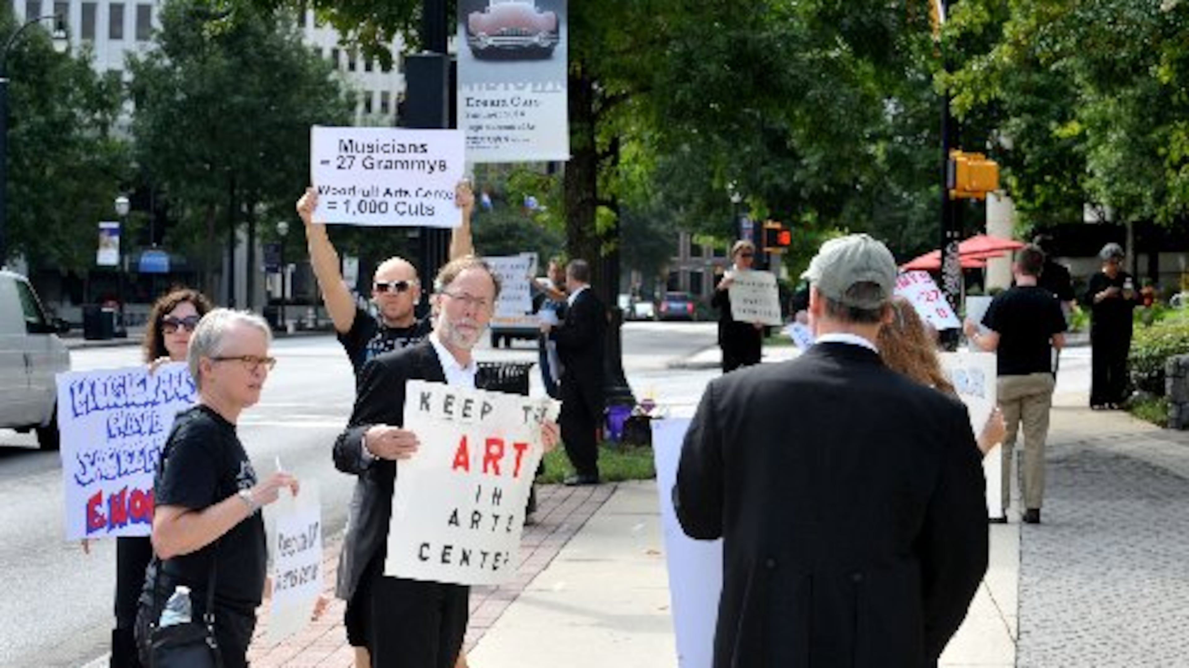 Atlanta Symphony Orchestra musicians and supporters picket in front of the Woodruff Arts Center Monday, September 8, 2014. A Saturday deadline passed without a deal in the Atlanta Symphony Orchestra’s collective bargaining agreement negotiations between management and the musicians. A statement released just past midnight by the Atlanta Symphony Orchestra Players Association said that the musicians believe they are being locked out by ASO management. It was followed momentarily by a statement from ASO management that warned that the 2014-15 season, which is scheduled to open Sept. 25, may be delayed or cancelled. KENT D. JOHNSON / KDJOHNSON@AJC.COM