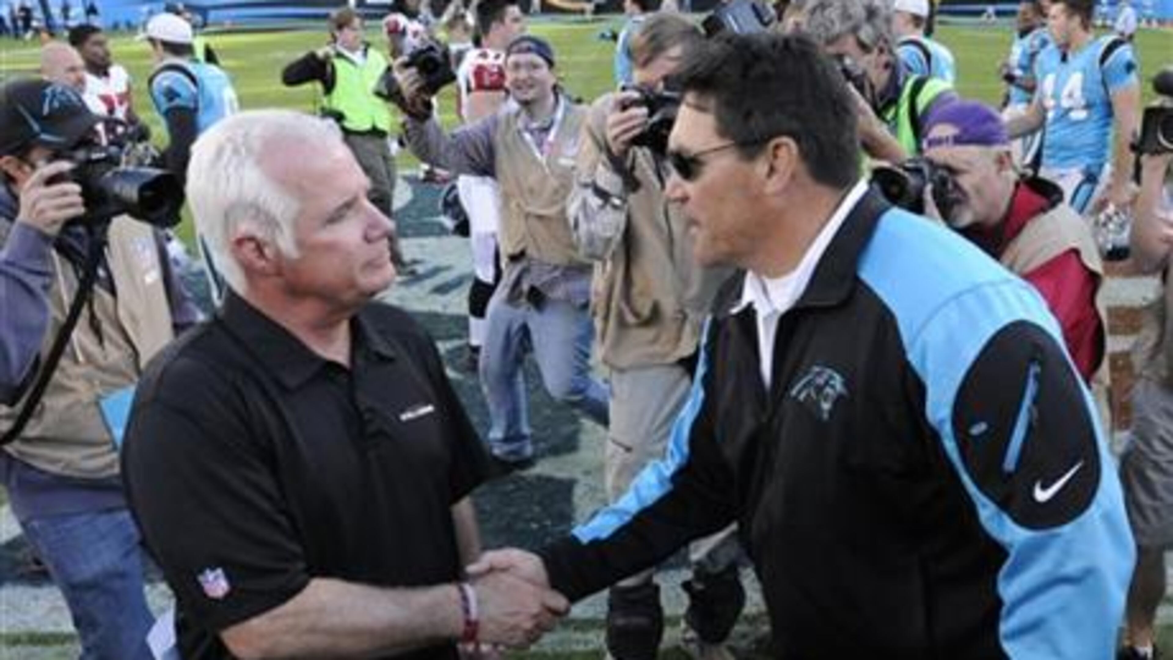 Carolina Panthers head coach Ron Rivera, right, shakes hands with Atlanta Falcons head coach Mike Smith after an NFL football game in Charlotte, N.C., Sunday, Nov. 3, 2013. The Panthers won 34-10. (AP Photo/Mike McCarn)