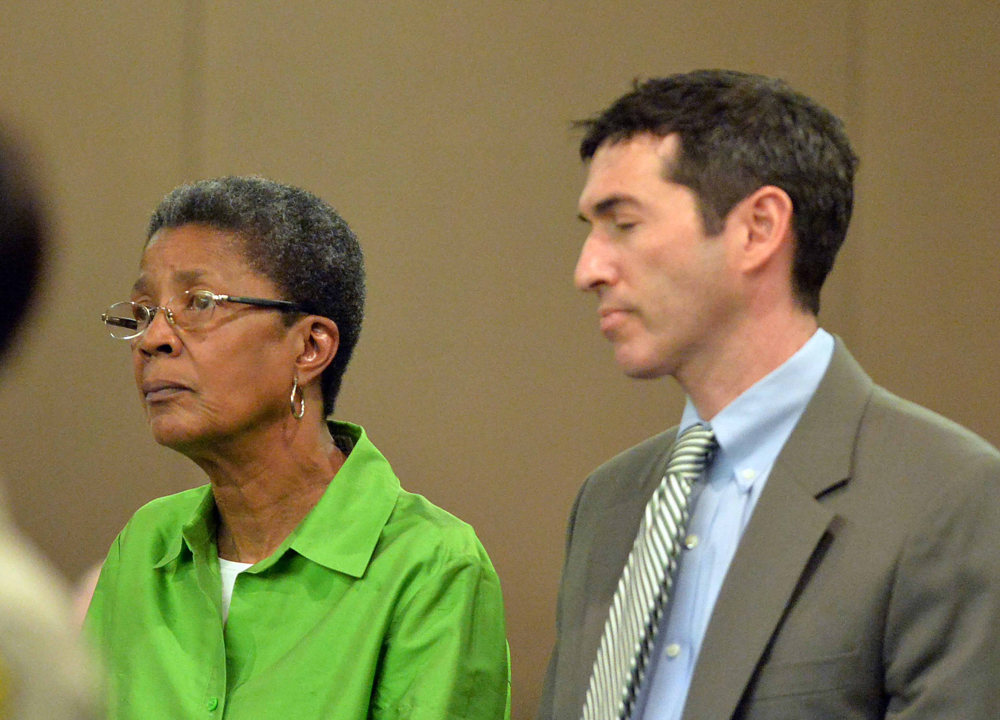 Former APS Dobbs Elementary teacher Dessa Curb stands with her defense attorney Sanford Wallack as she hears the verdict exonerating her of all charges Wednesday. A jury of six men and six women rendered their verdicts on the eighth day of deliberations in the Atlanta Public Schools test-cheating trial on Wednesday, April 1, 2015. Jurors sorted through roughly five months of testimony against 12 former educators accused of engaging in a racketeering conspiracy to inflate test scores. (Atlanta Journal-Constitution, Kent D. Johnson, Pool)