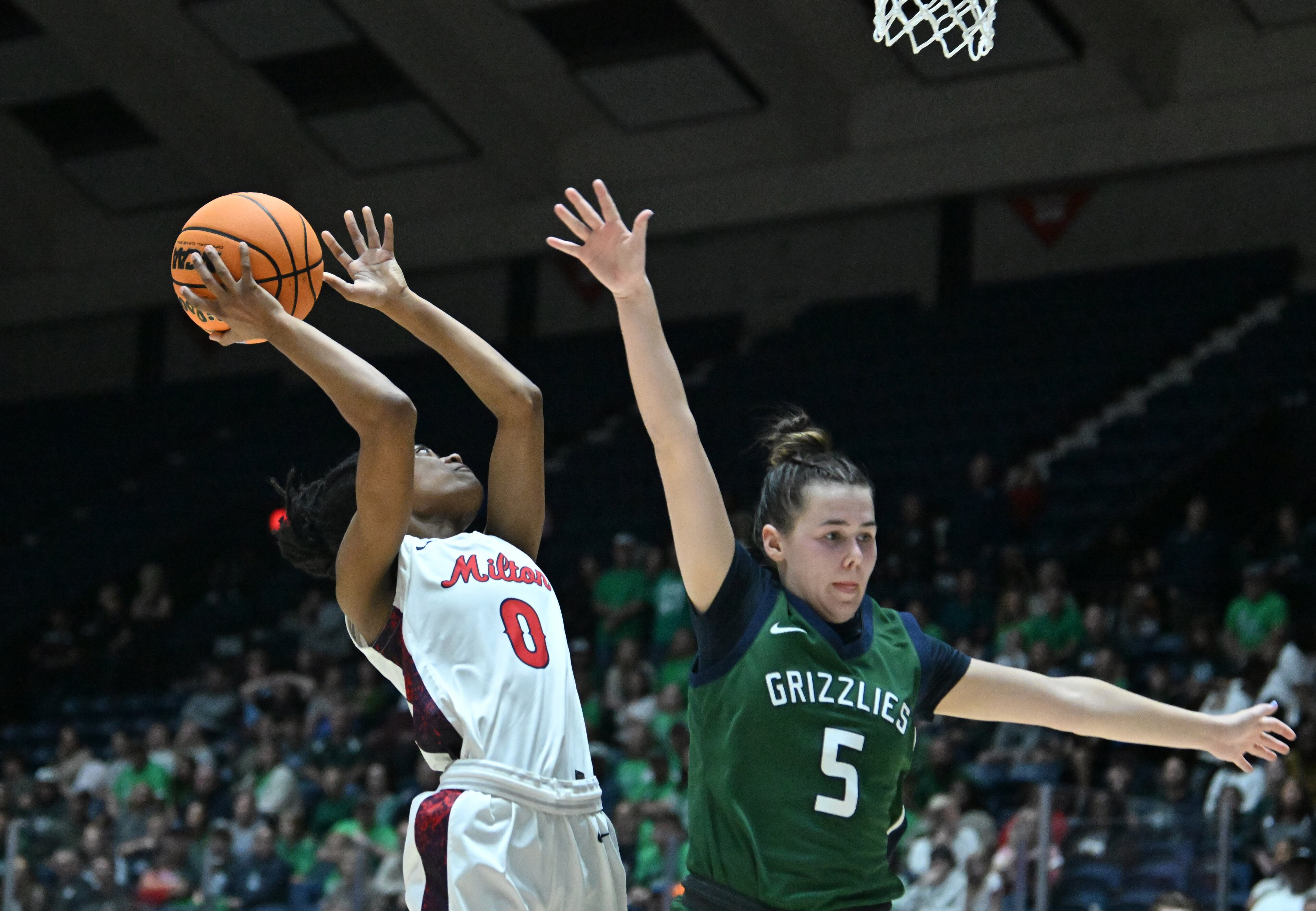 Milton’s Deyva Davis (0) goes to the basket for the shot against Creekview’s Finley Howard (5) during the second half of the Class 5A Girls GHSA State Championship at the Macon Coliseum, Friday, March 13, 2026, in Macon. Creekview won 45-43 over Milton. (Hyosub Shin/AJC)