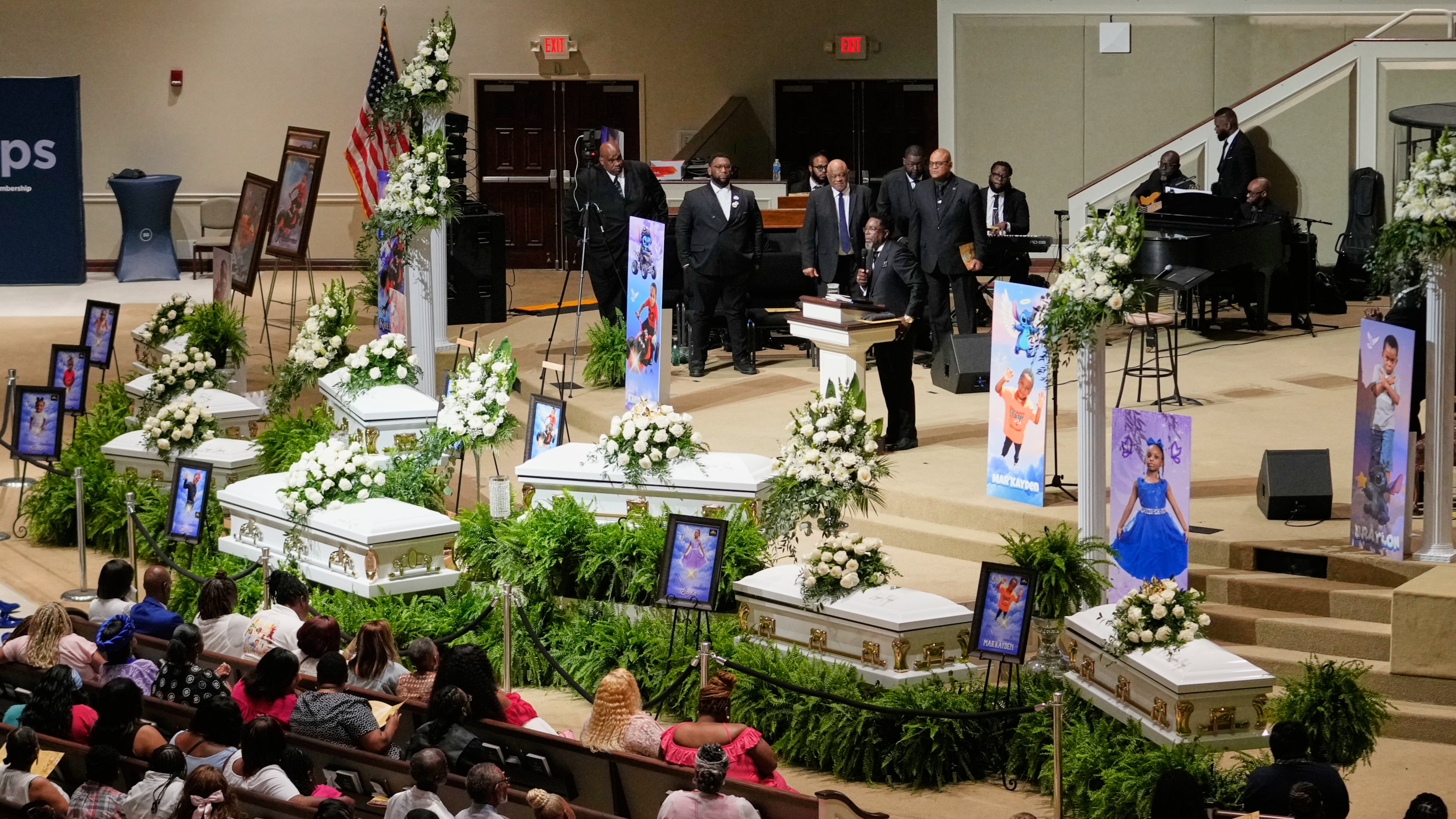 People listen during funeral services for the eight children who were killed during a mass shooting last month, Saturday, May 9, 2026, at the Summer Grove Baptist Church in Shreveport, La. (AP Photo/Gerald Herbert)