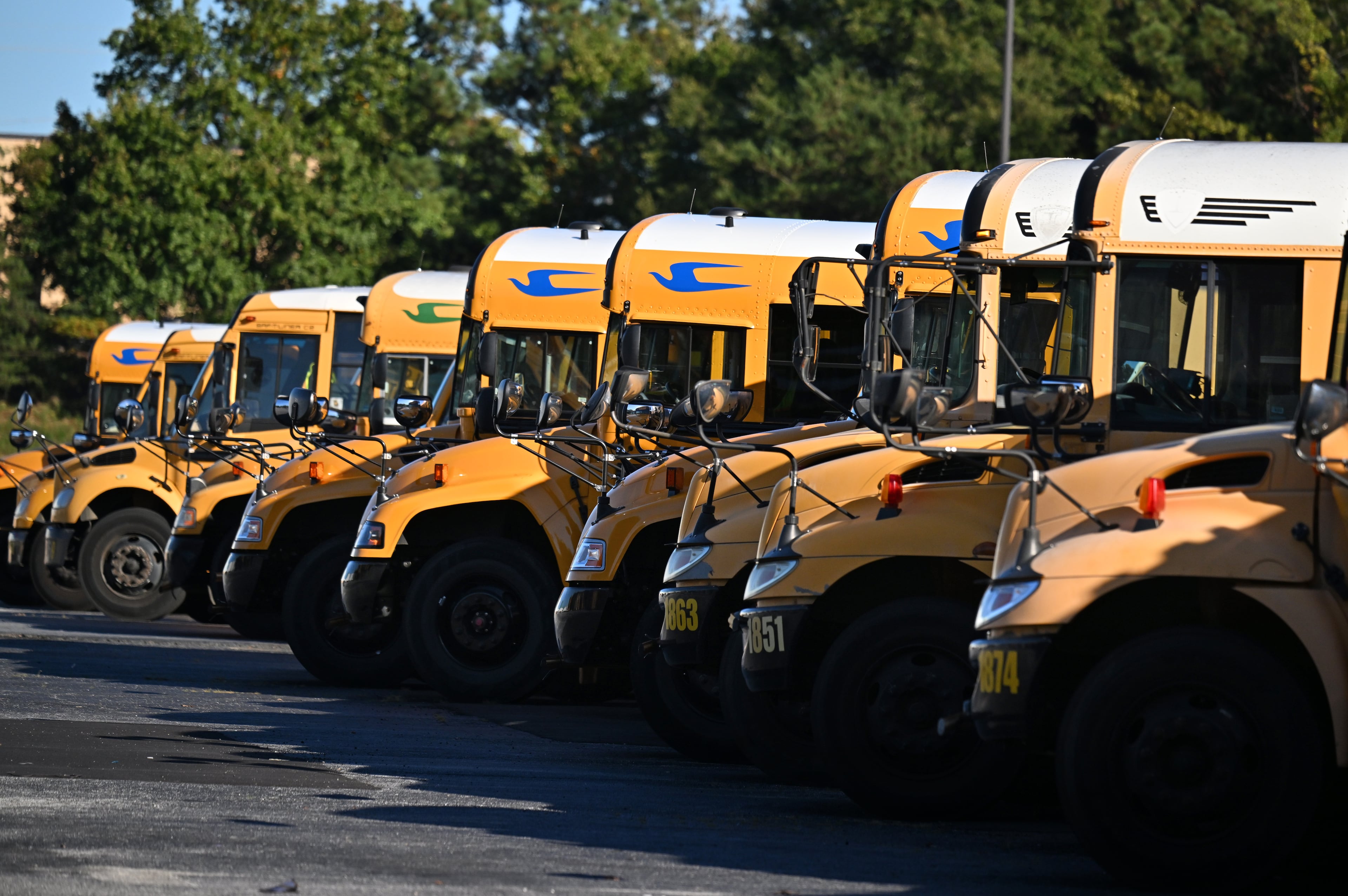 DeKalb County school buses are seen at DeKalb County School District headquarters, Wednesday, October 15, 2025, in Stone Mountain. The school district, and others across metro Atlanta, are canceling weekend activities ahead of this weekend's expected storm. (Hyosub Shin/AJC)