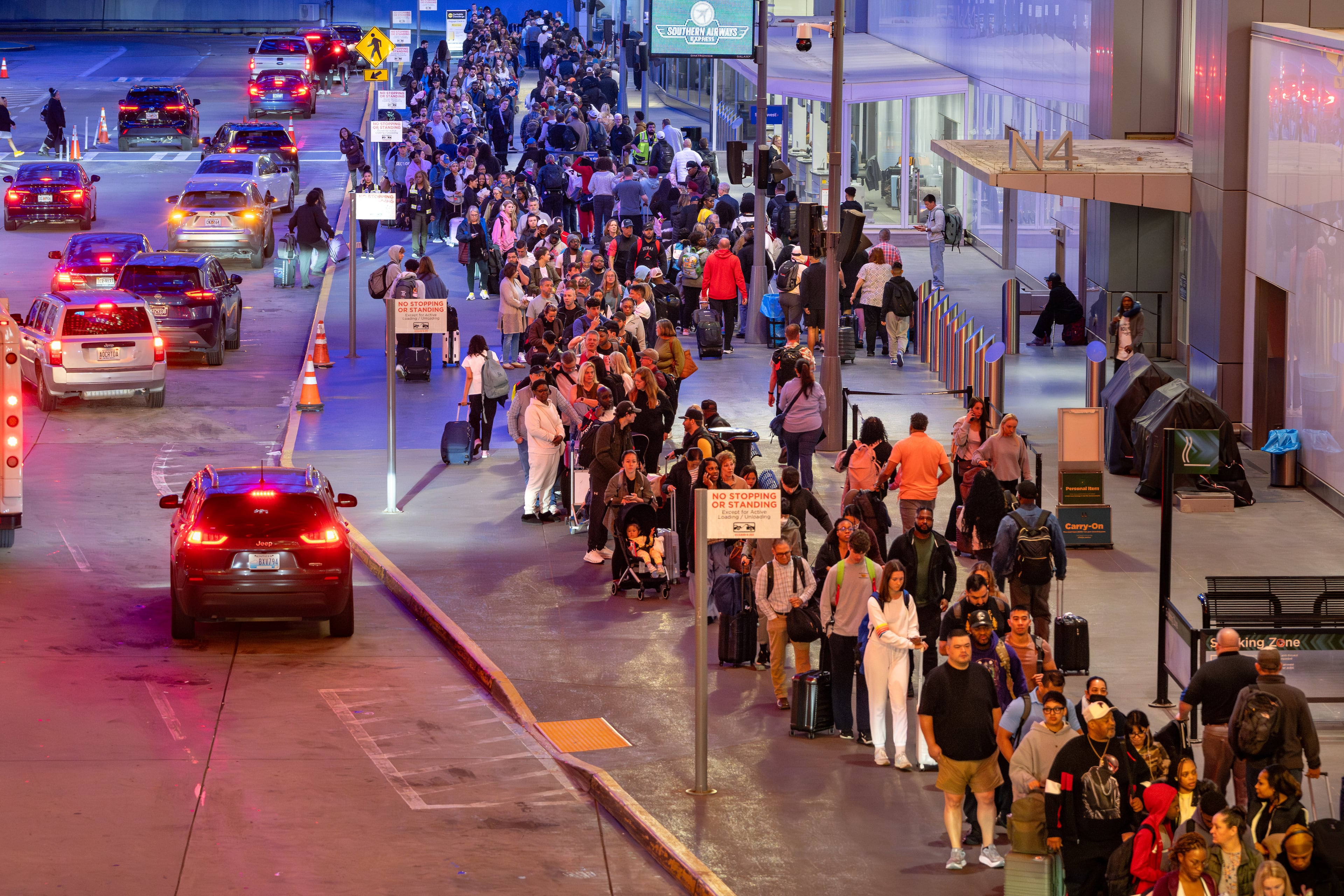 Lines for domestic security spill out of the north terminal onto the sidewalk at Hartsfield-Jackson Atlanta International Airport amid the ongoing partial government shutdown. Thursday, March 26, 2026 (Ben Hendren for the AJC)