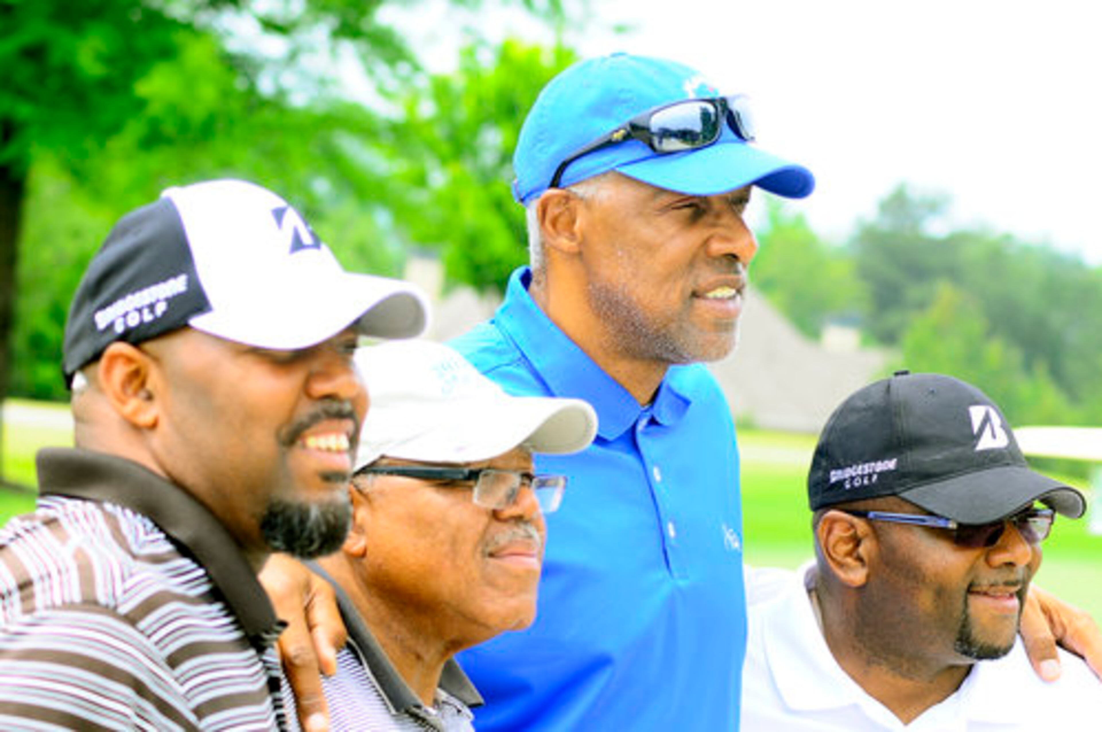 NBA great Julius "Dr. J" Erving takes a photo with his golfing group.