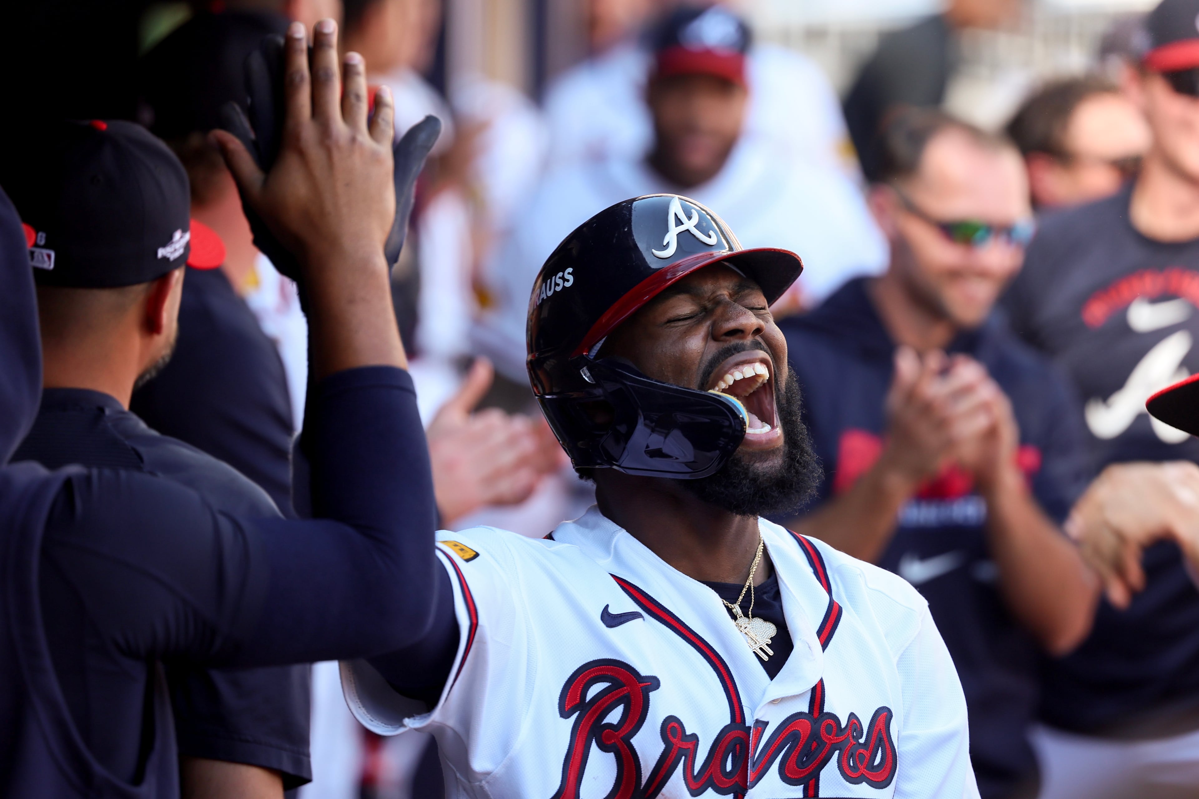 Michael Harris II celebrates in the dugout after scoring in the sixth inning. (Jason Getz/AJC)