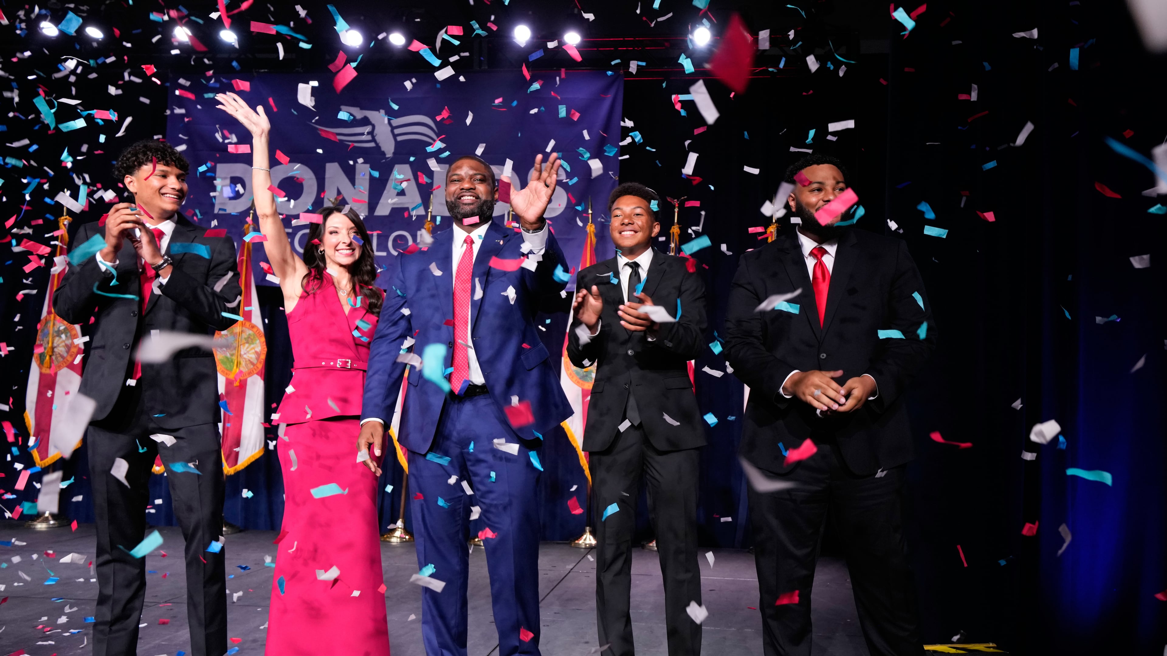 Florida Republican gubernatorial candidate Byron Donalds, center, waves next to his wife Erika, while standing on stage with their children Darin, left, Damon, second from left, and Mason during at a primary election party Tuesday, Aug. 18, 2026, in Orlando, Fla. (AP Photo/John Raoux)