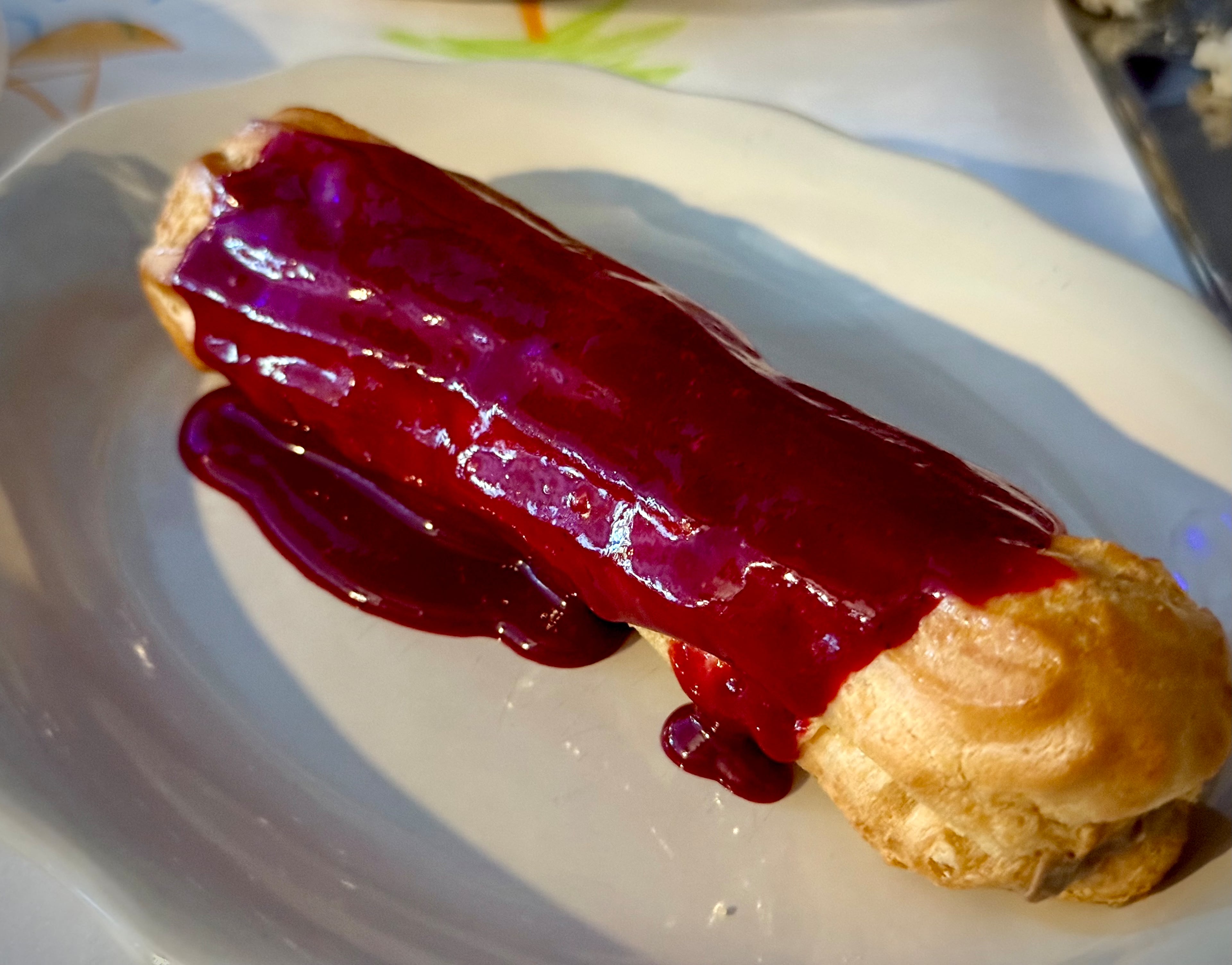 The liver eclair at Last Dance in Avondale Estates is topped with a blackberry-lemon balm glaze. (Henri Hollis/AJC)