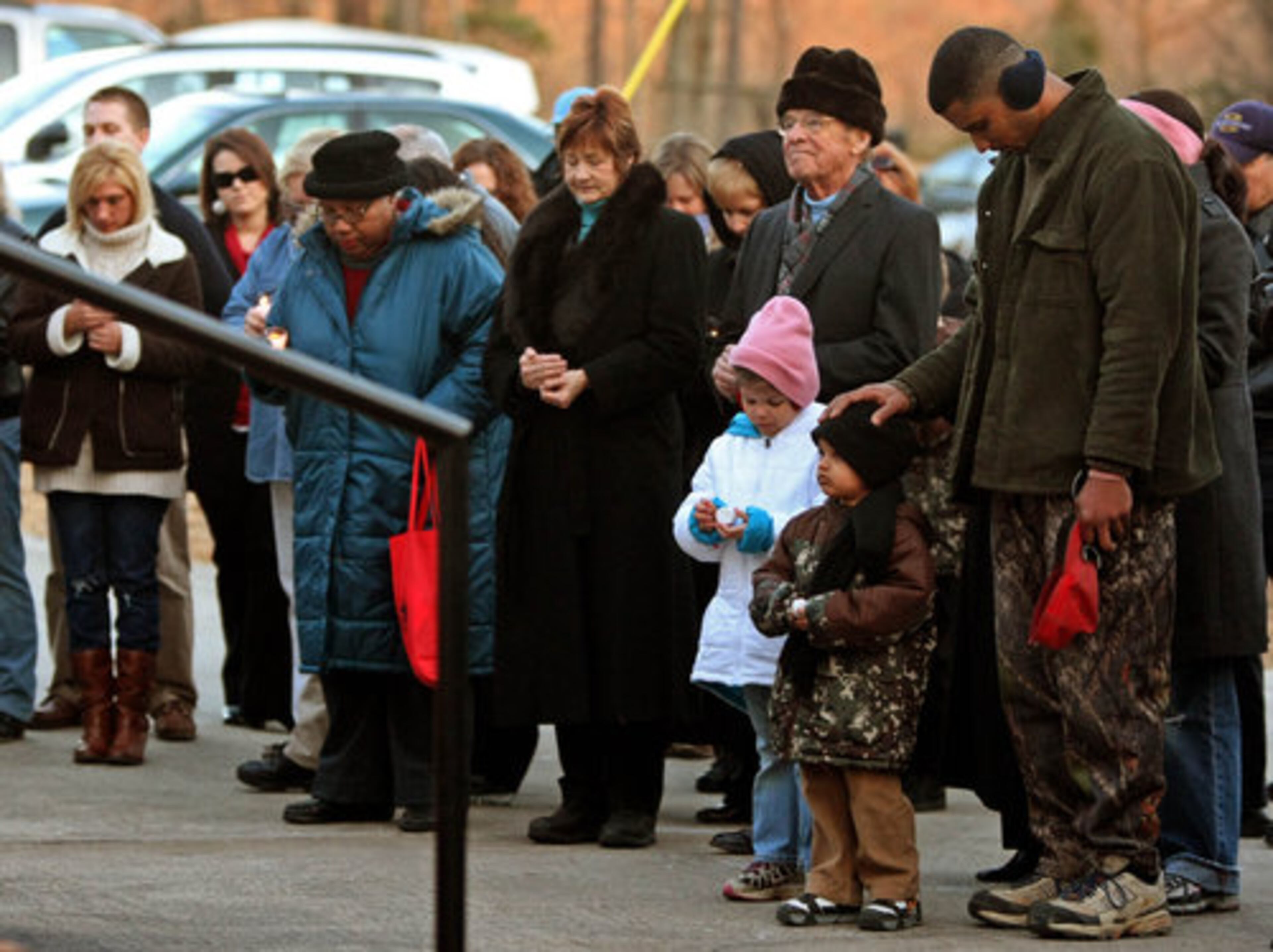 Members of the Chattahoochee Hills community attend a prayer vigil for officer Mike Vogt, who was killed in the line of duty Monday.