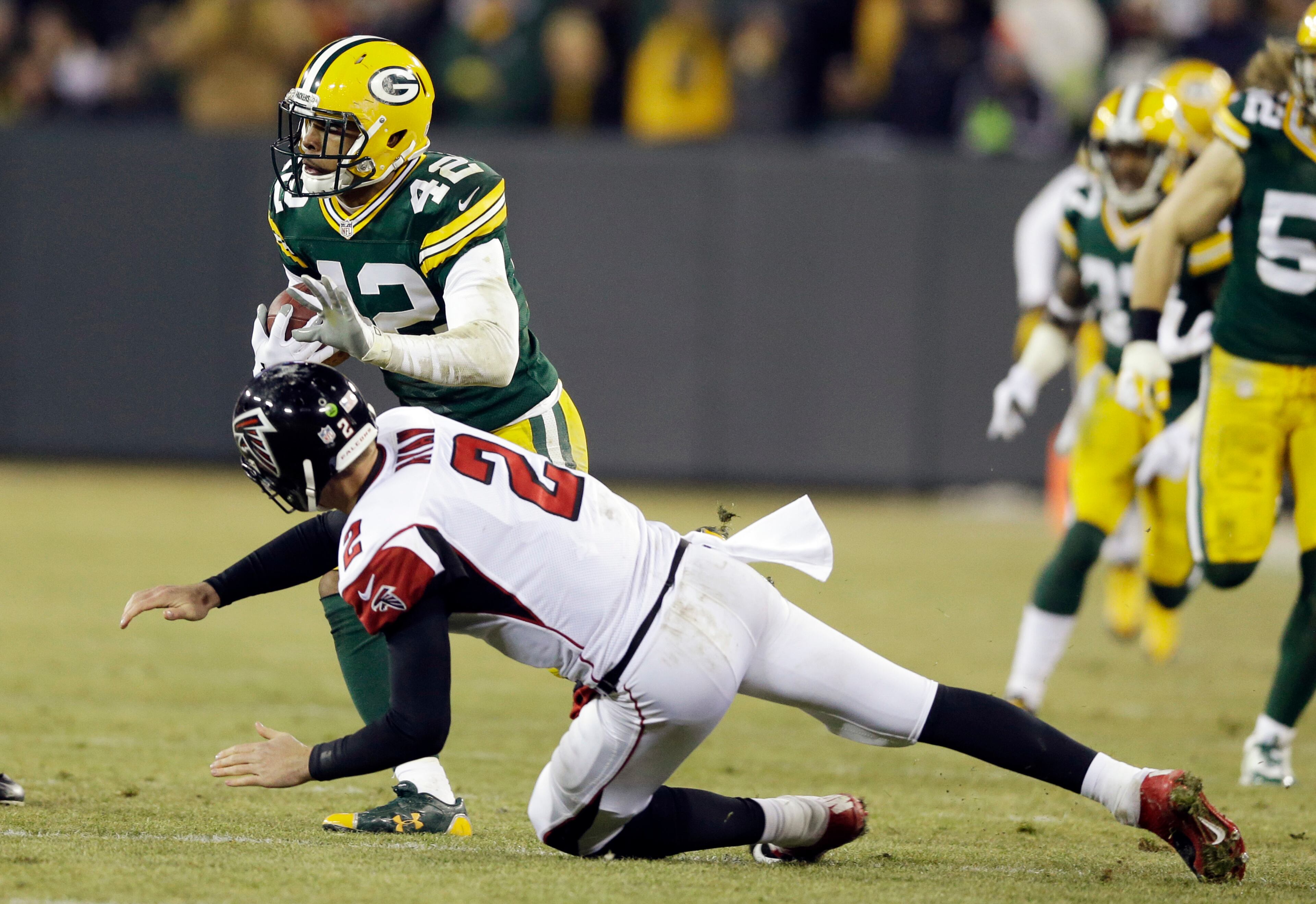 Atlanta Falcons quarterback Matt Ryan (2) tries to tackle Green Bay Packers' Morgan Burnett (42) after an interception during the first half Monday, Dec. 8, 2014, in Green Bay, Wis.
