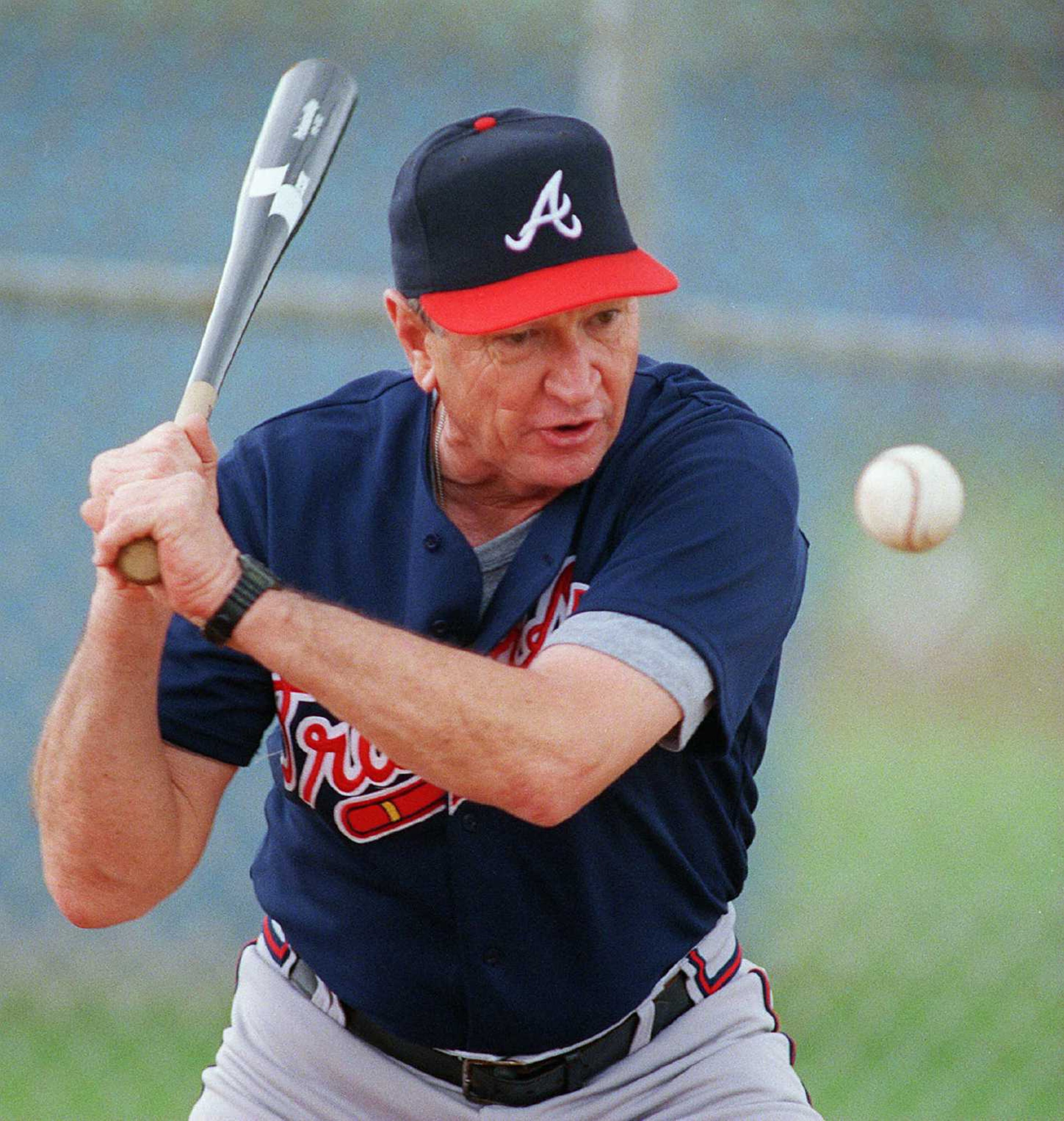 970219-WEST PALM BEACH, FL: Atlanta Braves coach Bobby Dews hits grounders to pitchers on the practice field mound during spring training at West Palm Municipal Stadium on Wednesday, February 19, 1997. (AJC staff photo/Phil Skinner)