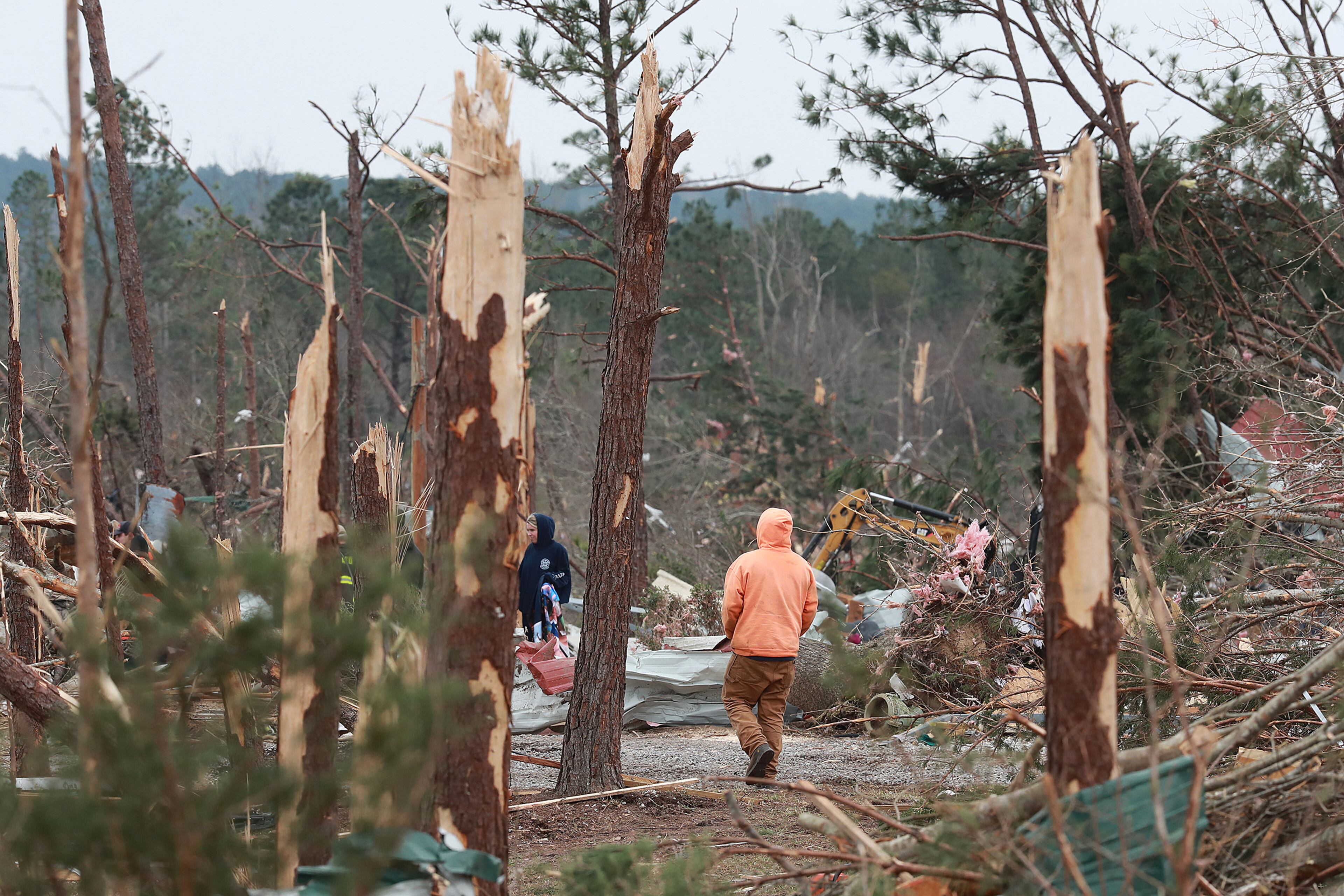 A local resident makes his way along Lee Road 38 after a F-3 tornado on Monday, March 4, 2019, in Beauregard. Twenty-three people -- including a six-year-old -- were killed by a storm Sunday, though that number is expected to climb, Lee County Sheriff Jay Jones told reporters Monday morning. The destruction area is at least a half a mile wide and at least a mile long, he added. Curtis Compton/ccompton@ajc.com