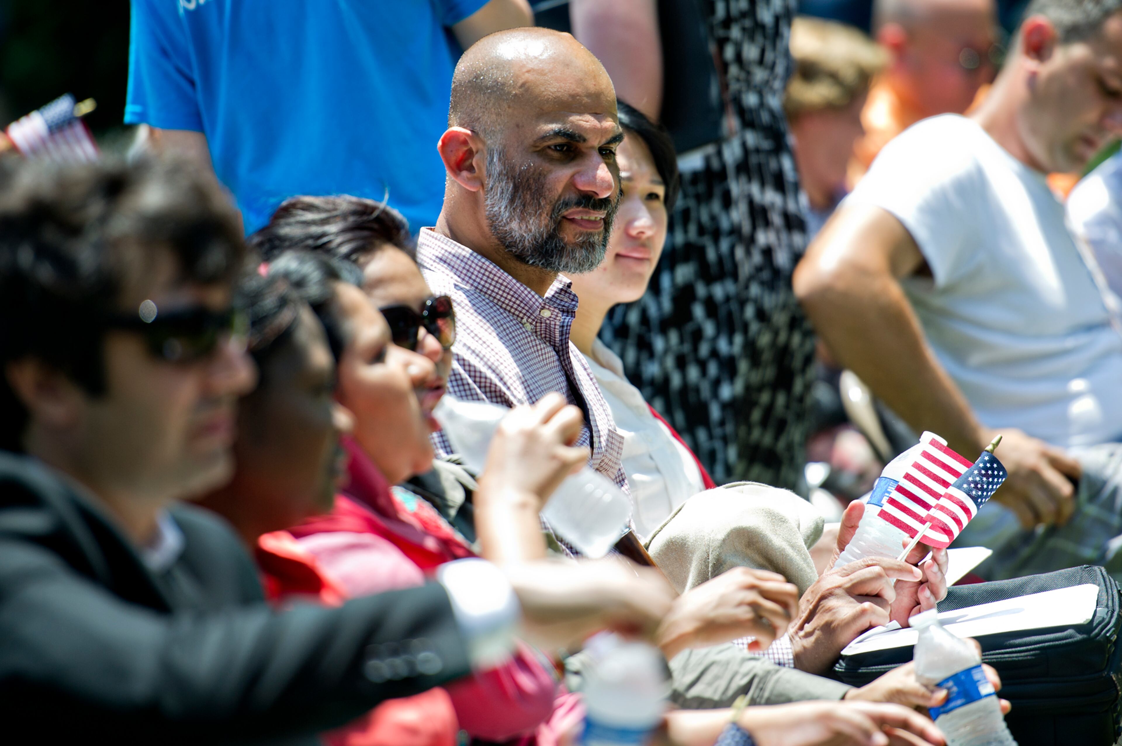 Muhamed Alfargani (right) waits to become a naturalized citizen of the United States during the World Refugee Day celebration at the Clarkston Community Center in Clarkston on Saturday, June 21, 2014. The celebration included food, performances and a naturalization ceremony for 20 refugees and asylees from 12 different countries including Ghana, Iraq, Iran, Bosnia and Kenya. JONATHAN PHILLIPS / SPECIAL