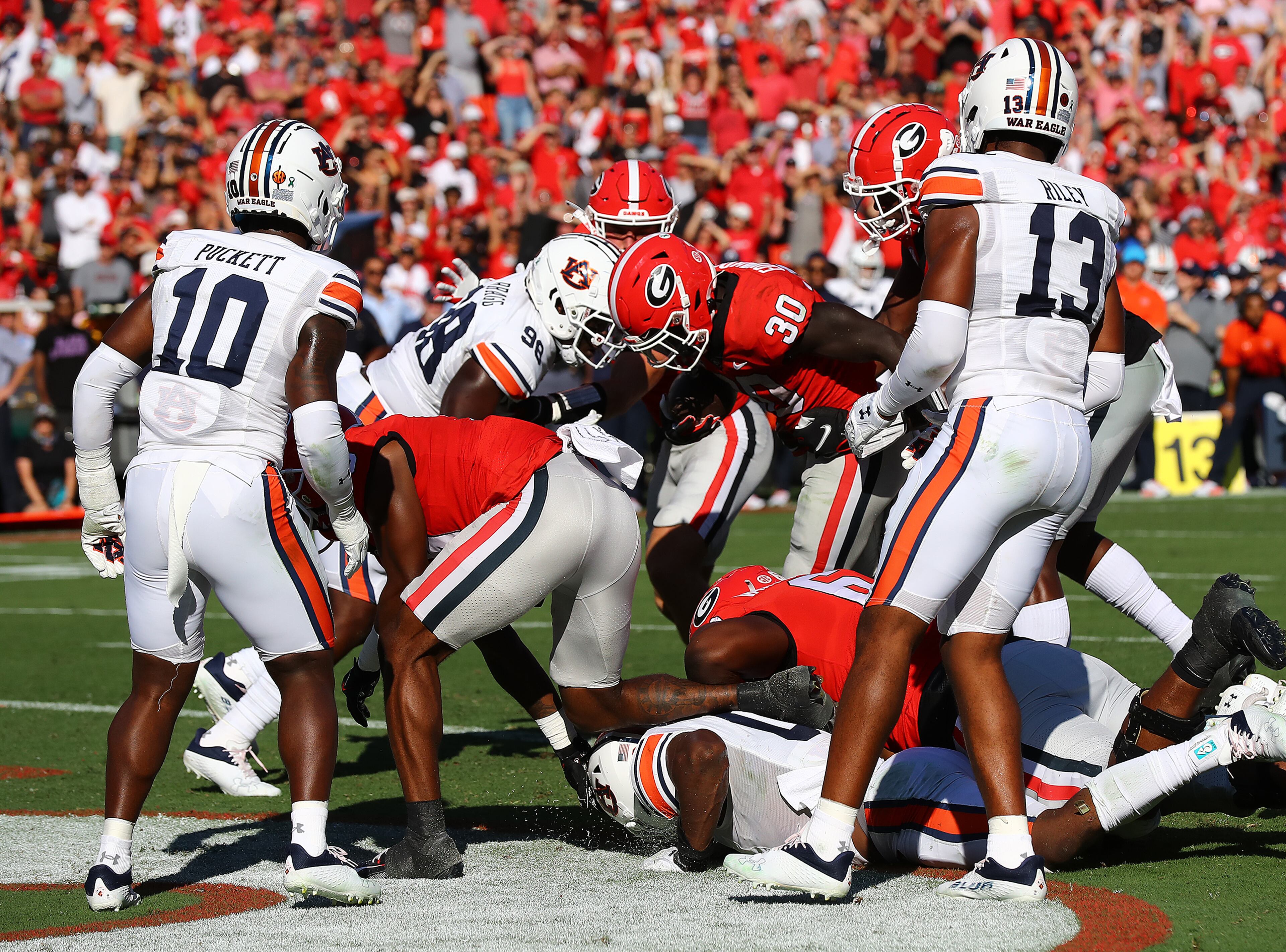 Georgia running back Daijun Edwards (center) makes a short touchdown run through Auburn defenders to take a 14-0 lead during the second quarter in a NCAA college football game on Saturday, Oct. 8, 2022, in Athens. Curtis Compton / Curtis Compton@ajc.com