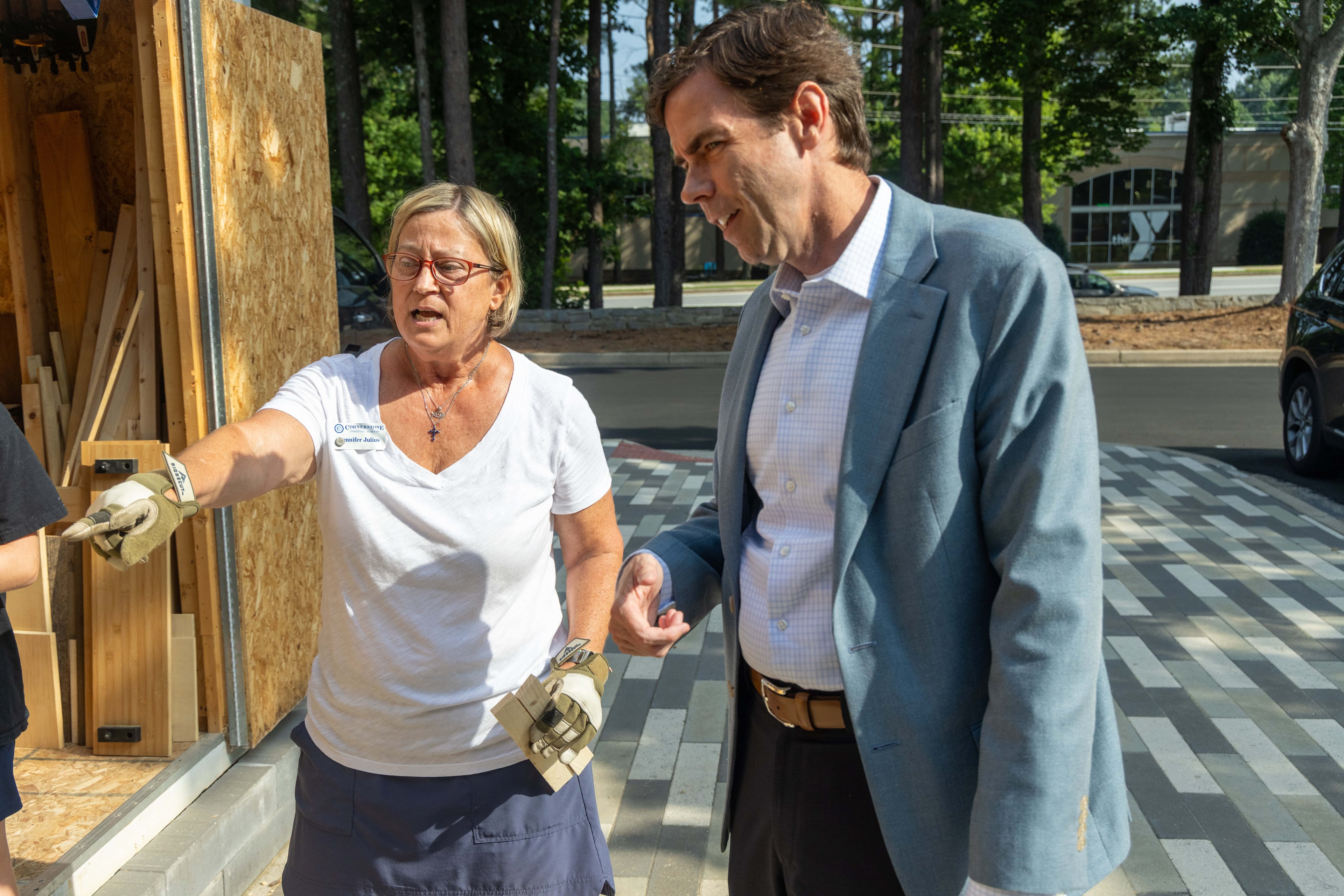 Cornerstone Christian Academy woodworking teacher Jennifer Julius (left) speaks with headmaster Colin Creel. The private school in Peachtree Corners has been named the No. 1 small workplace by the AJC for the third straight year. (Phil Skinner for the AJC)