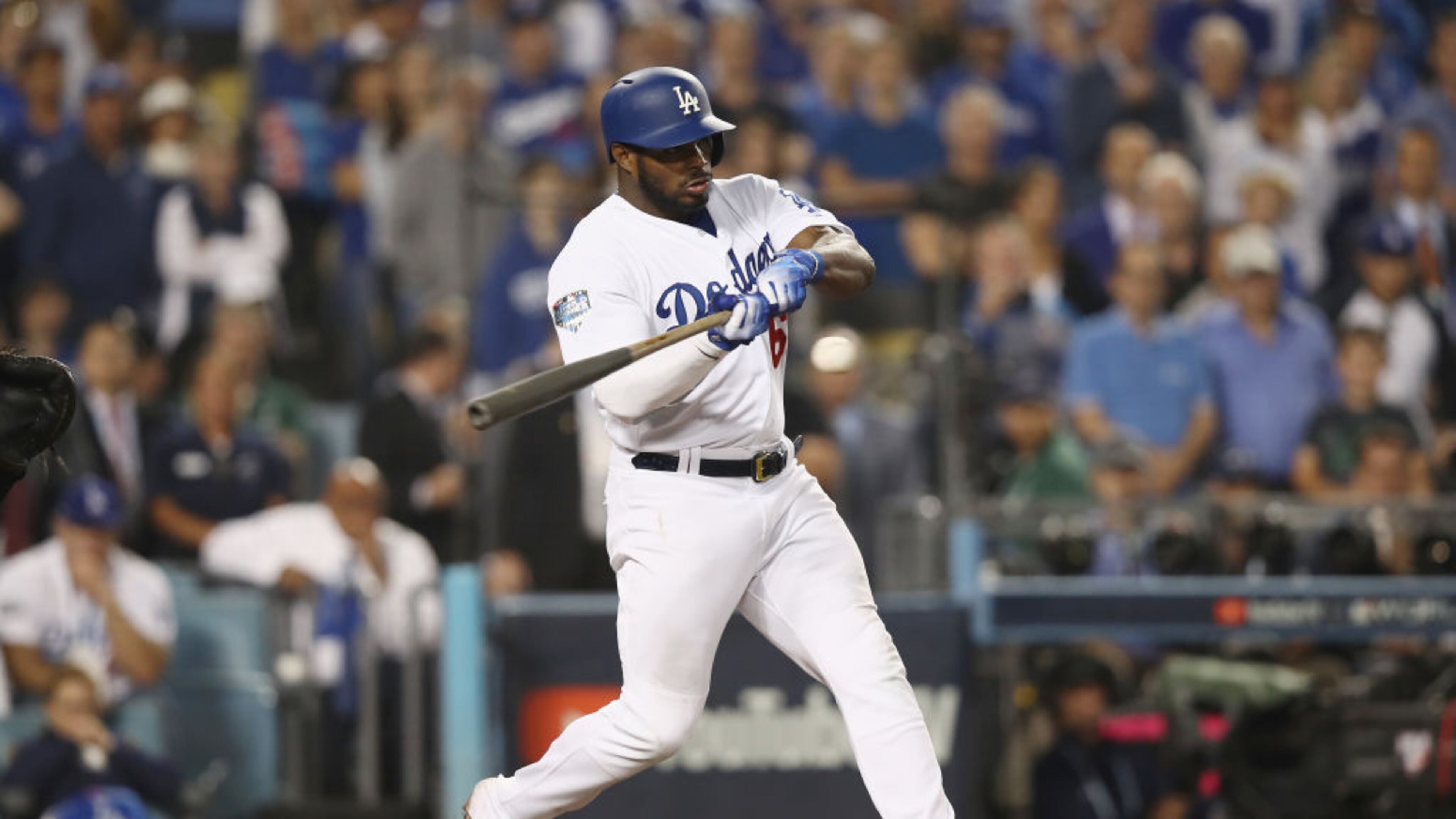 Yasiel Puig of the Los Angeles Dodgers hits a single that brings home the tying run during the 13th inning against the Boston Red Sox in Game Three of the 2018 World Series.