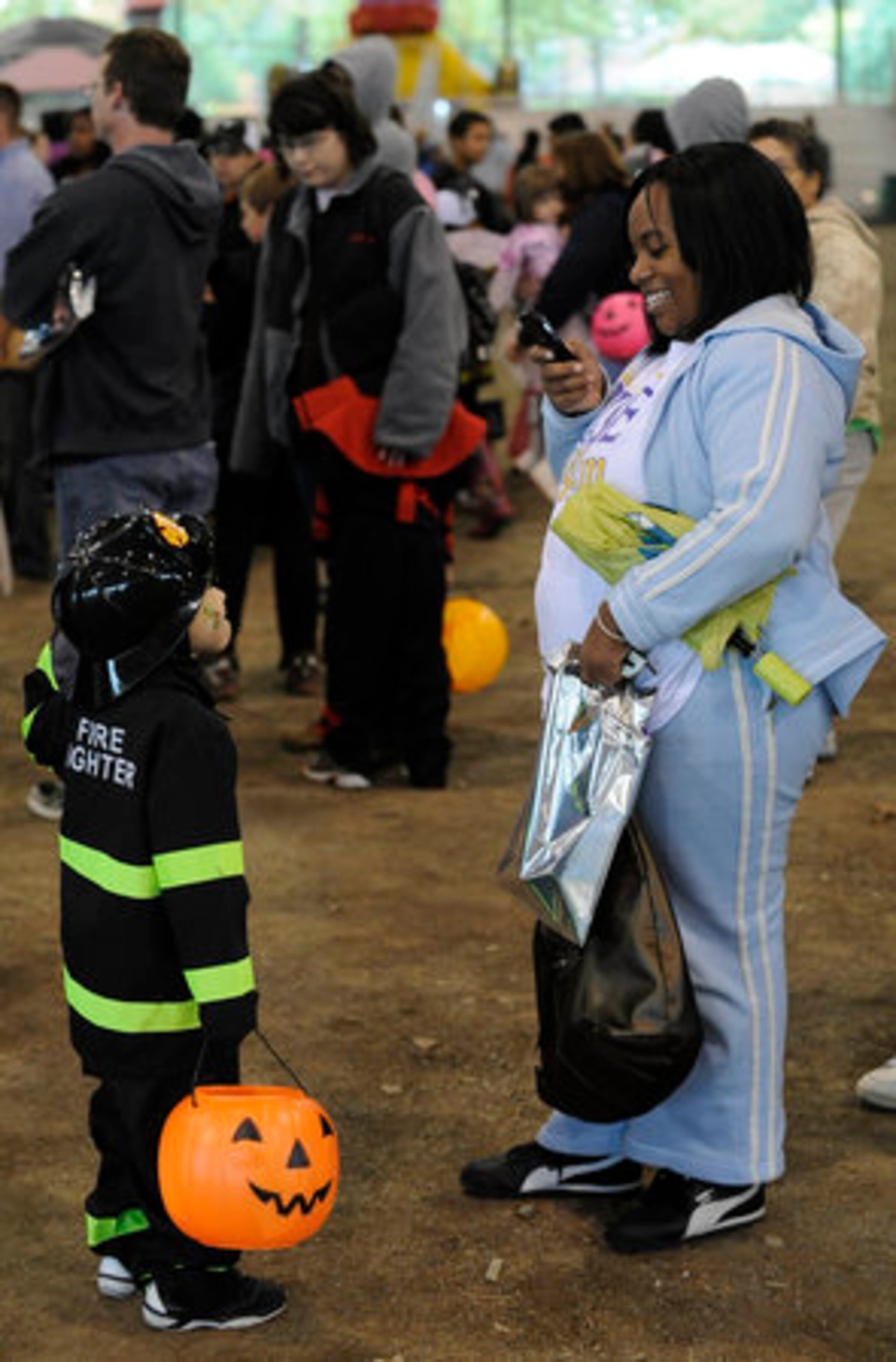 Desiree Wright, of Smyrna, takes a picture of her 4-year-old son Andre Wright during the Fall Festival of Fun Saturday afternoon at Jim R. Miller Park in Marietta. The Festival included arts and crafts, games, inflatable rides, police and fire prevention activities, costume and coloring contests, a photo booth and lots more family fun.