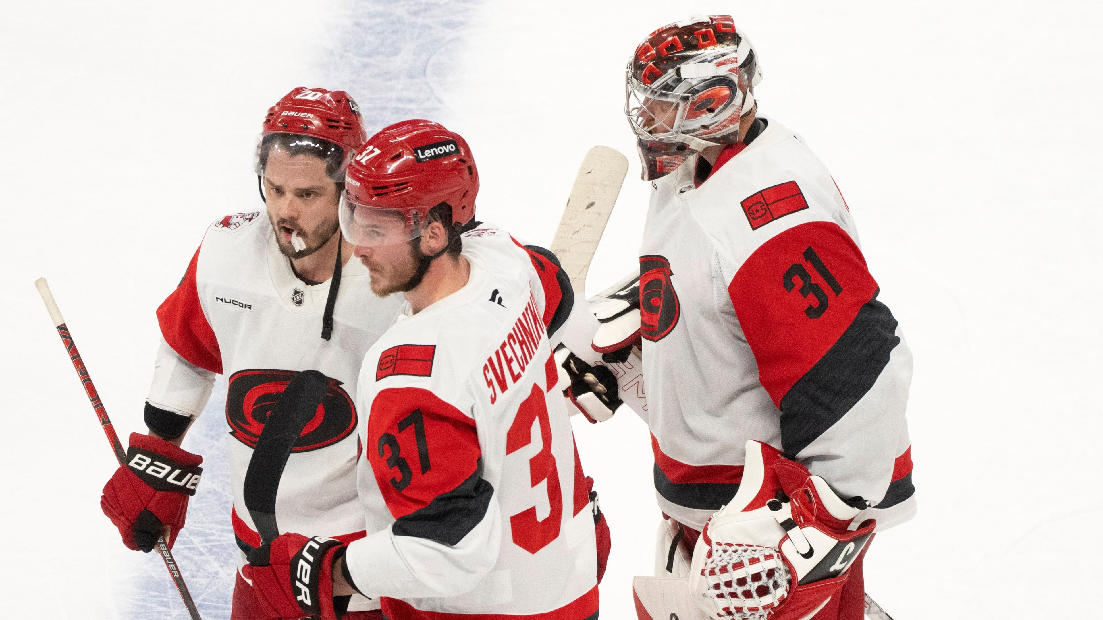 Carolina Hurricanes' Sebastian Aho (20) and Andrei Svechnikov (37) celebrate in front of Hurricanes goaltender Frederik Andersen (31) after the winning goal by Aho in overtime of Game 3 of the Eastern Conference finals NHL hockey Stanley Cup playoff series against the Montreal Canadiens in Montreal, Monday, May 25, 2026. (Christinne Muschi/The Canadian Press via AP)