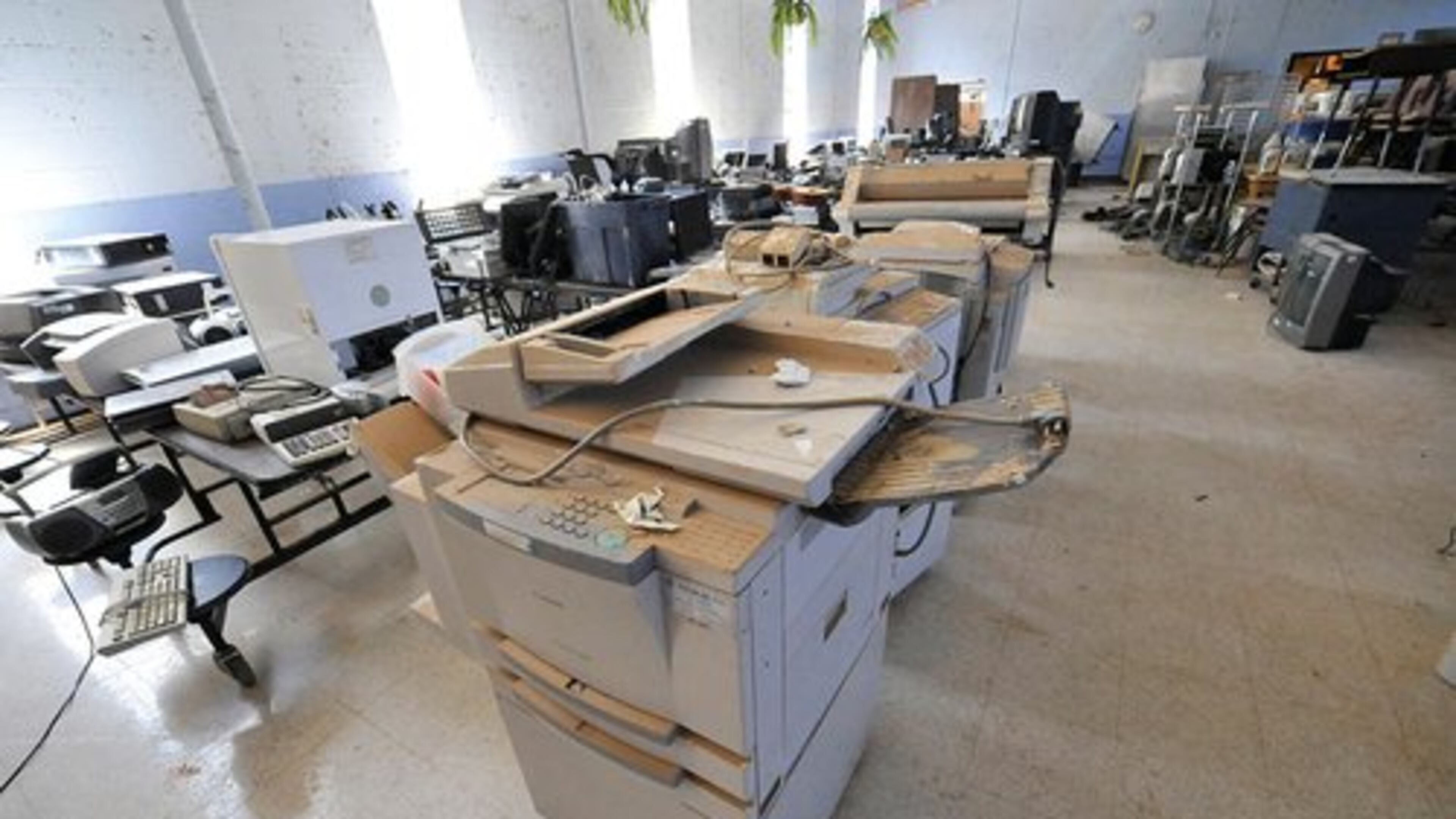 Ruined items like this copier were placed in the school's lunchroom for inventory.