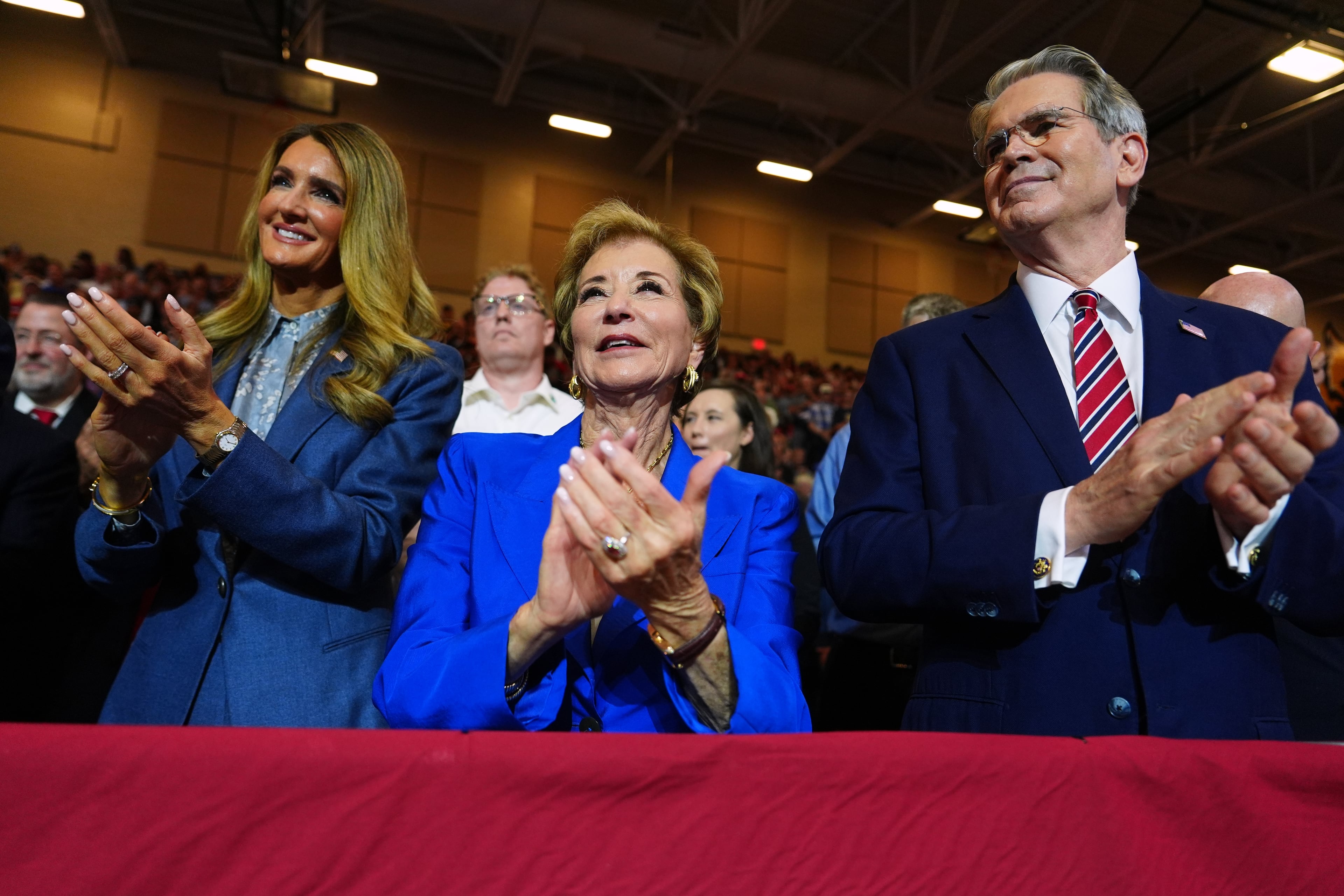 Small Business Administration Administrator Kelly Loeffler (left), Secretary of Education Linda McMahon and Treasury Secretary Scott Bessent applaud as President Donald Trump speaks at Wheeler High School on Wednesday, July 22, 2026, in Marietta. (Julia Demaree Nikhinson/AP)