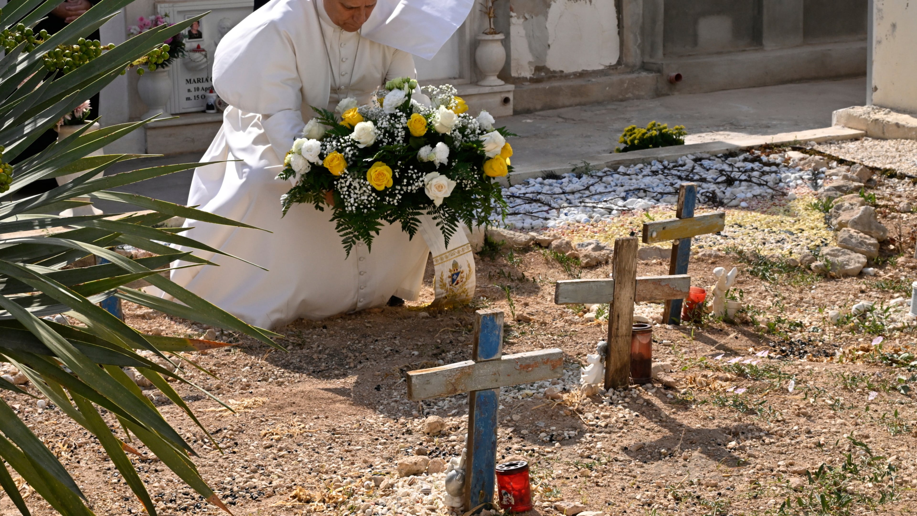 Pope Leo XIV pays tribute at the cemetery and on little Joussef's grave, in Lampedusa, Sicily, southern Italy, Saturday, July 4, 2026, during a one-day pastoral visit to an island that has become a symbol of the risks faced by migrants trying to reach Europe by sea.(Pool Photo/Ciro Fusco, Via AP)